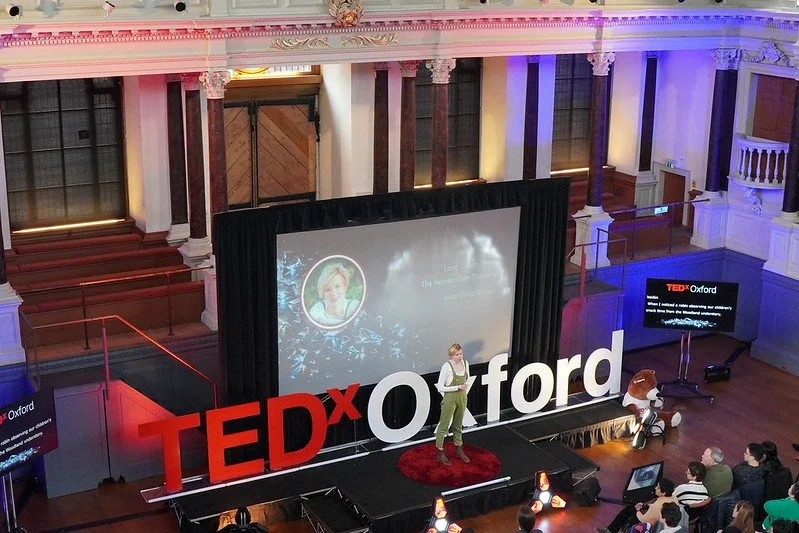 Lucy Grabe-Watson at TEDx Oxford speaking, January 2026 Official Photo from far away