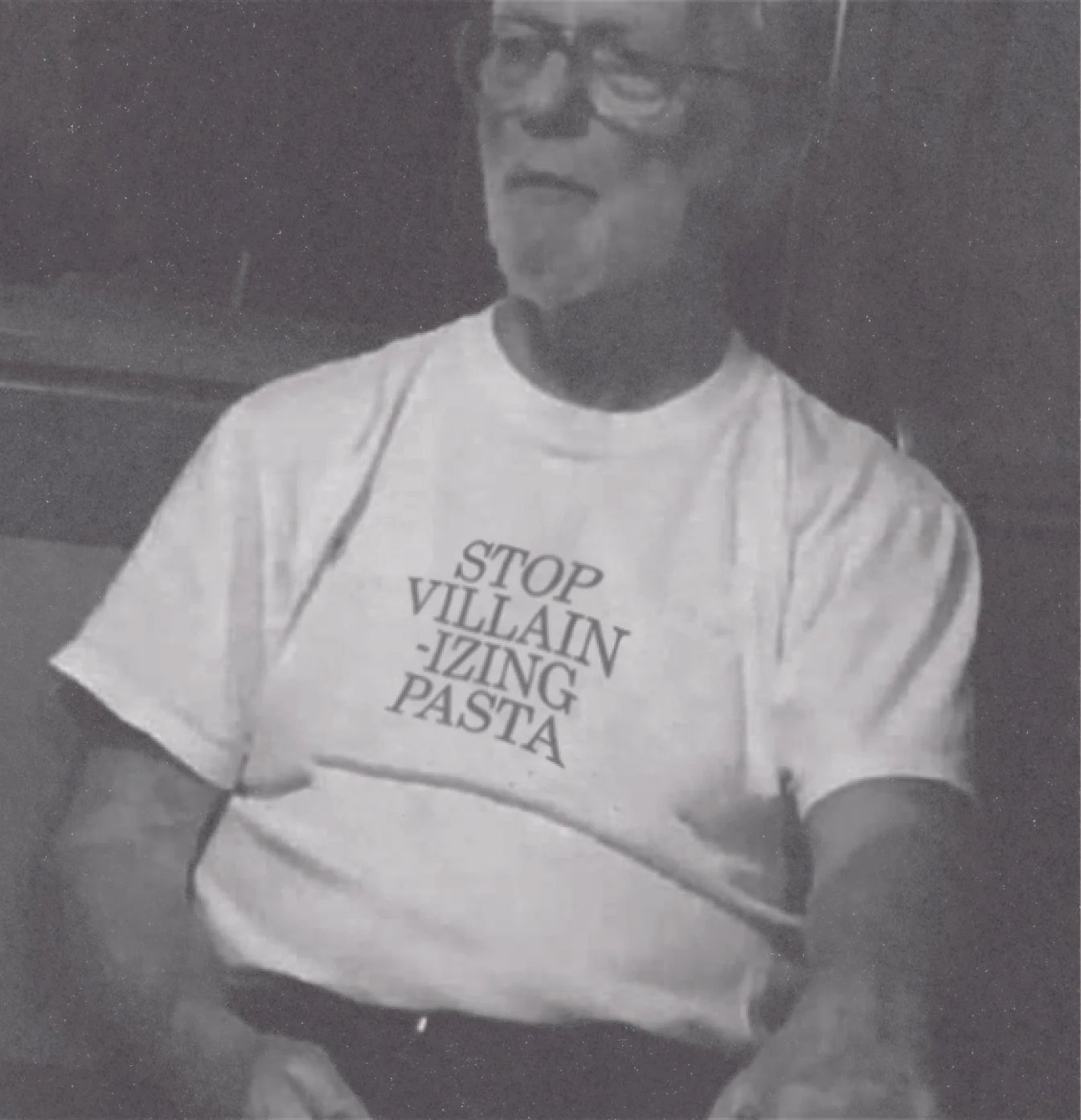 A person wearing glasses and a t-shirt with the text "STOP VILLAIN-IZING PASTA" printed on it.