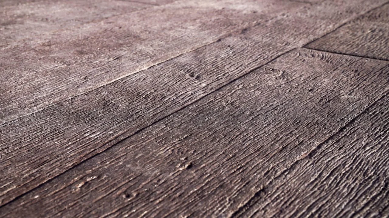 Close-up image of a weathered wooden surface or flooring.