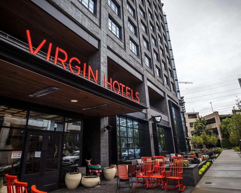 Exterior view of Virginia Hotels with outdoor seating area and modern building architecture.