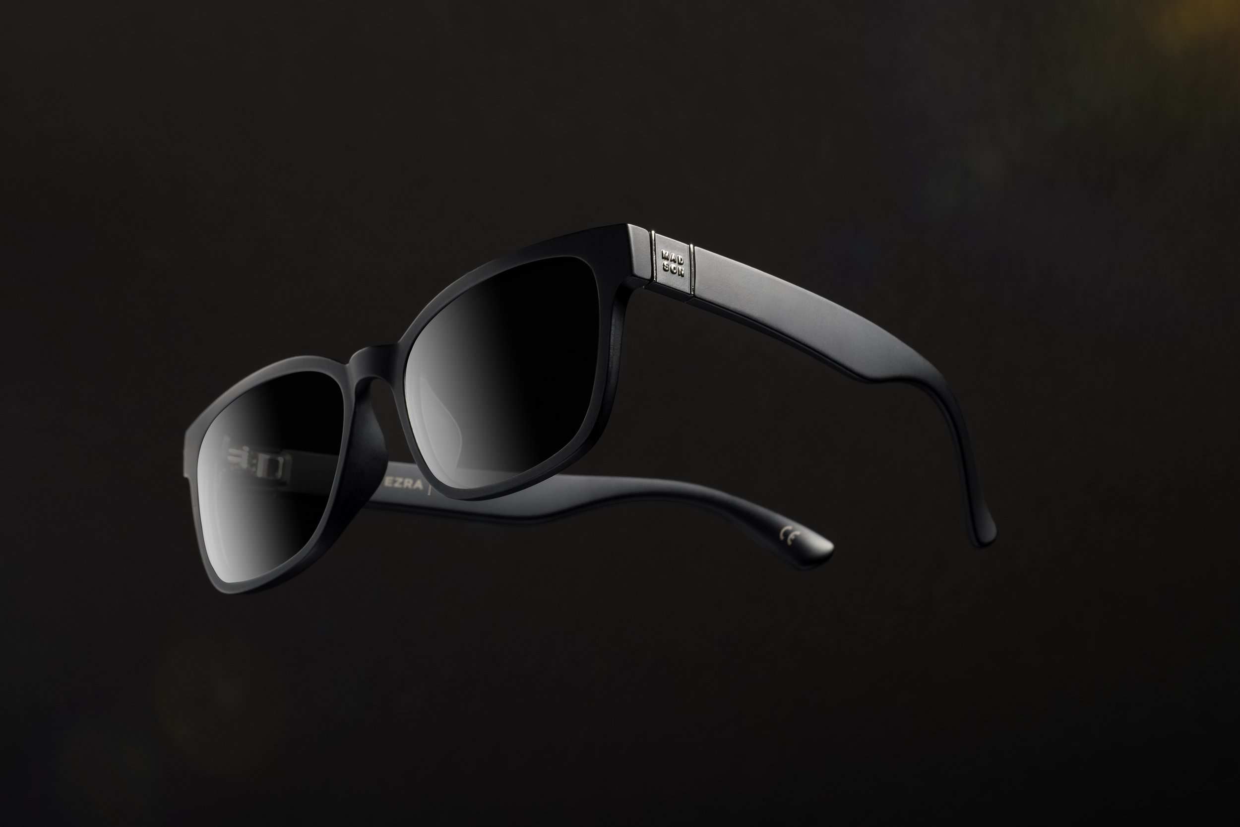 Black sunglasses with dark lenses on a dark background