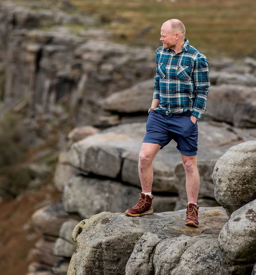 Danny Bent standing on large rocks outdoors