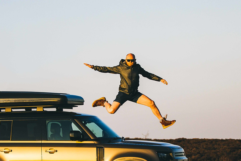 Danny Bent jumping from a vehicle during an outdoor adventure, expressing freedom and movement