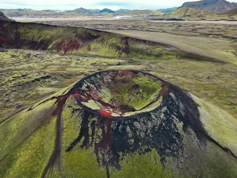 Aerial view of a volcanic crater in Iceland with moss-covered terrain
