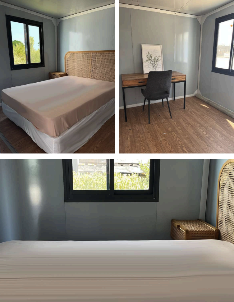 A room with a bed, desk, and window views displaying simple, modern decor.