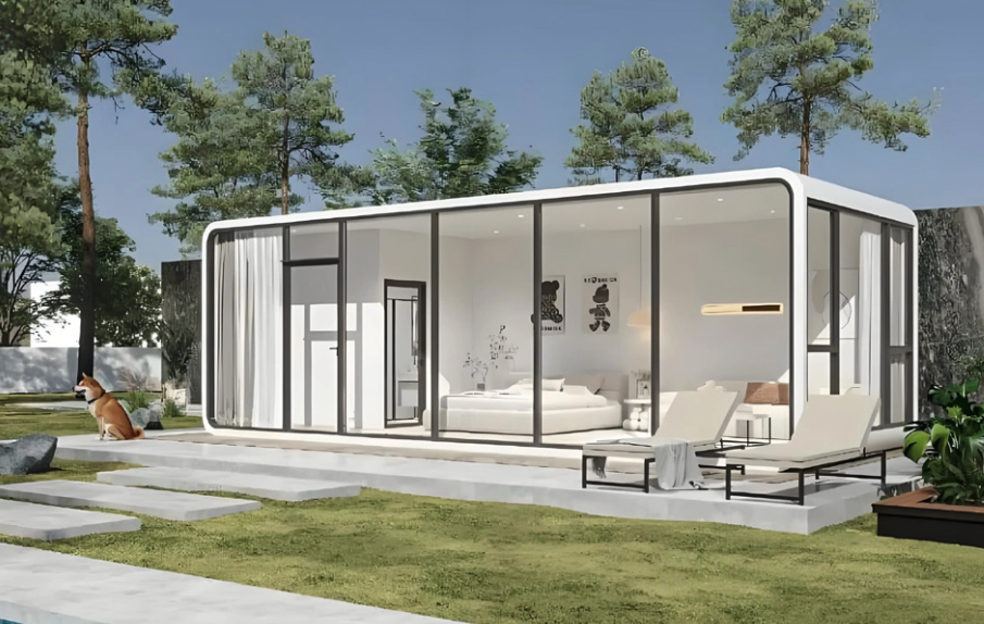 Modern glass house with white exterior, large windows, outdoor lounge chairs, and a dog sitting on the grass, surrounded by trees.