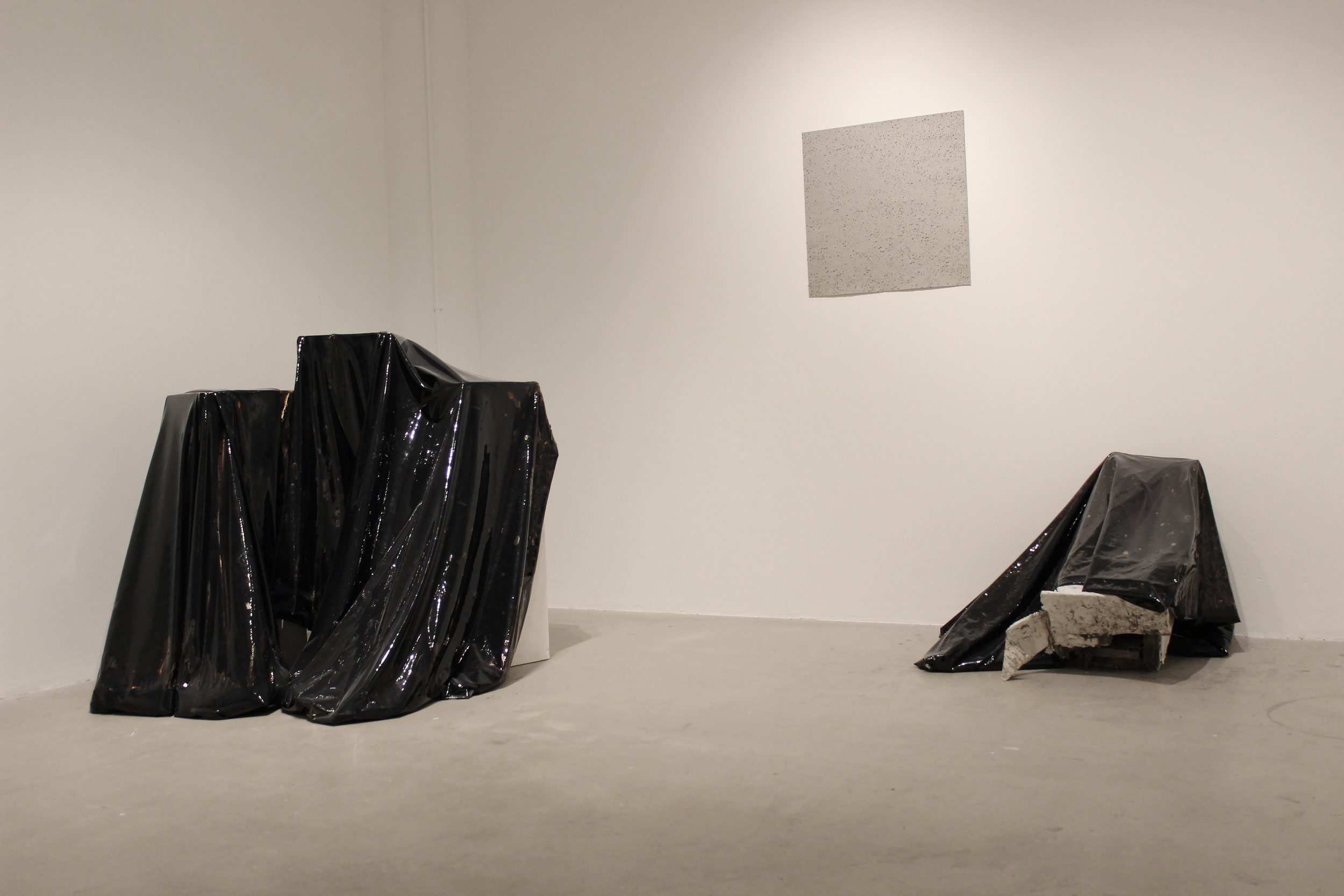  Liquid tar encapsulated in vinyl with found architectural objects 