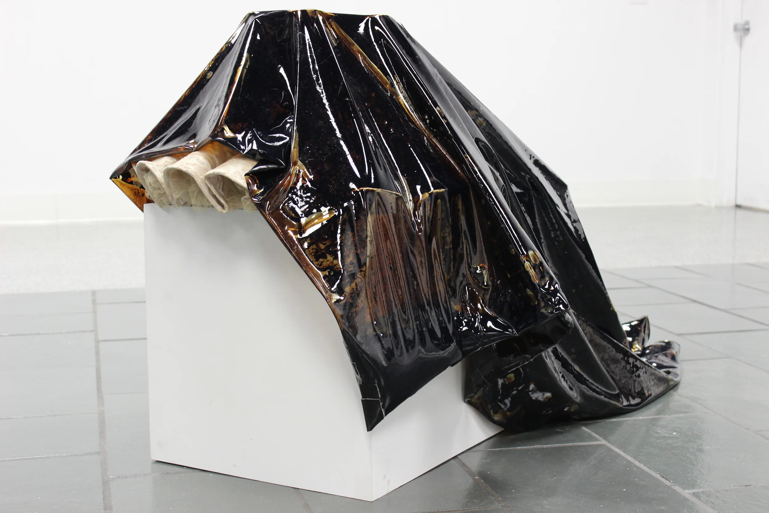  Liquid tar encapsulated in vinyl, gallery pedestal, found object (lamp shade) 