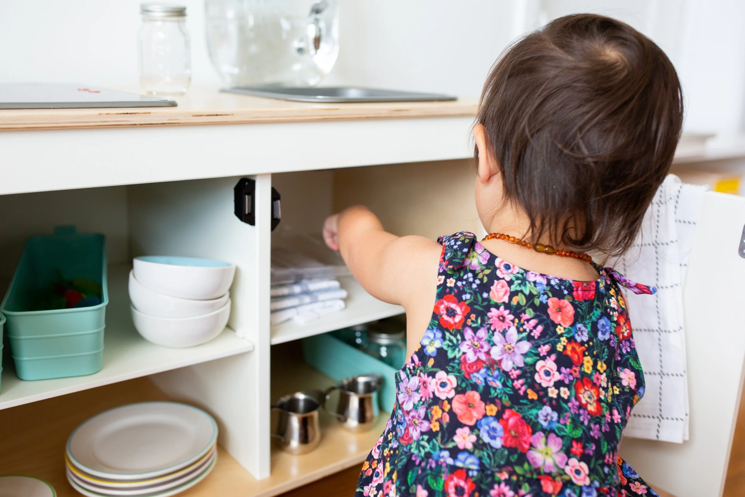 Toddler shelf in a Montessori prepared environment promoting independence and autonomy for babied and toddlers curated by a certified montessori guide