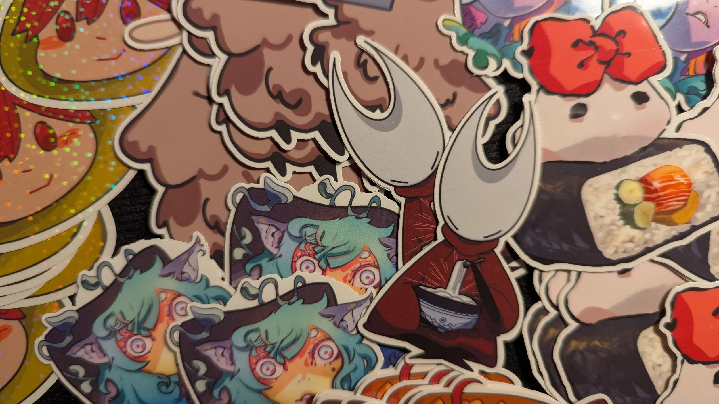 A collection of colorful cartoon stickers, including Vocaloids, a character with teal hair and goat-like features, and various other stylized illustrations of food and characters with vibrant colors and bold outlines.