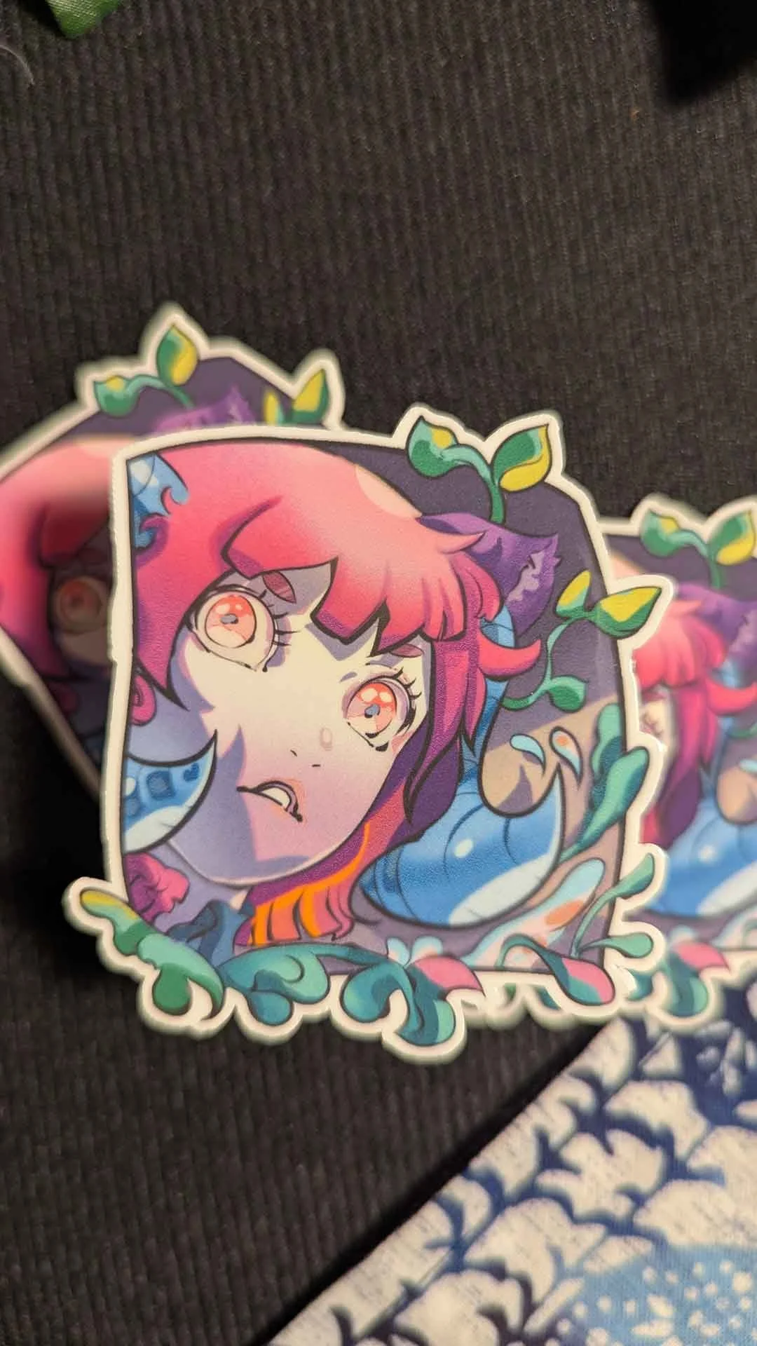 Colorful sticker of a girl with pink and purple hair, styled with leaves, with vibrant, detailed artwork.