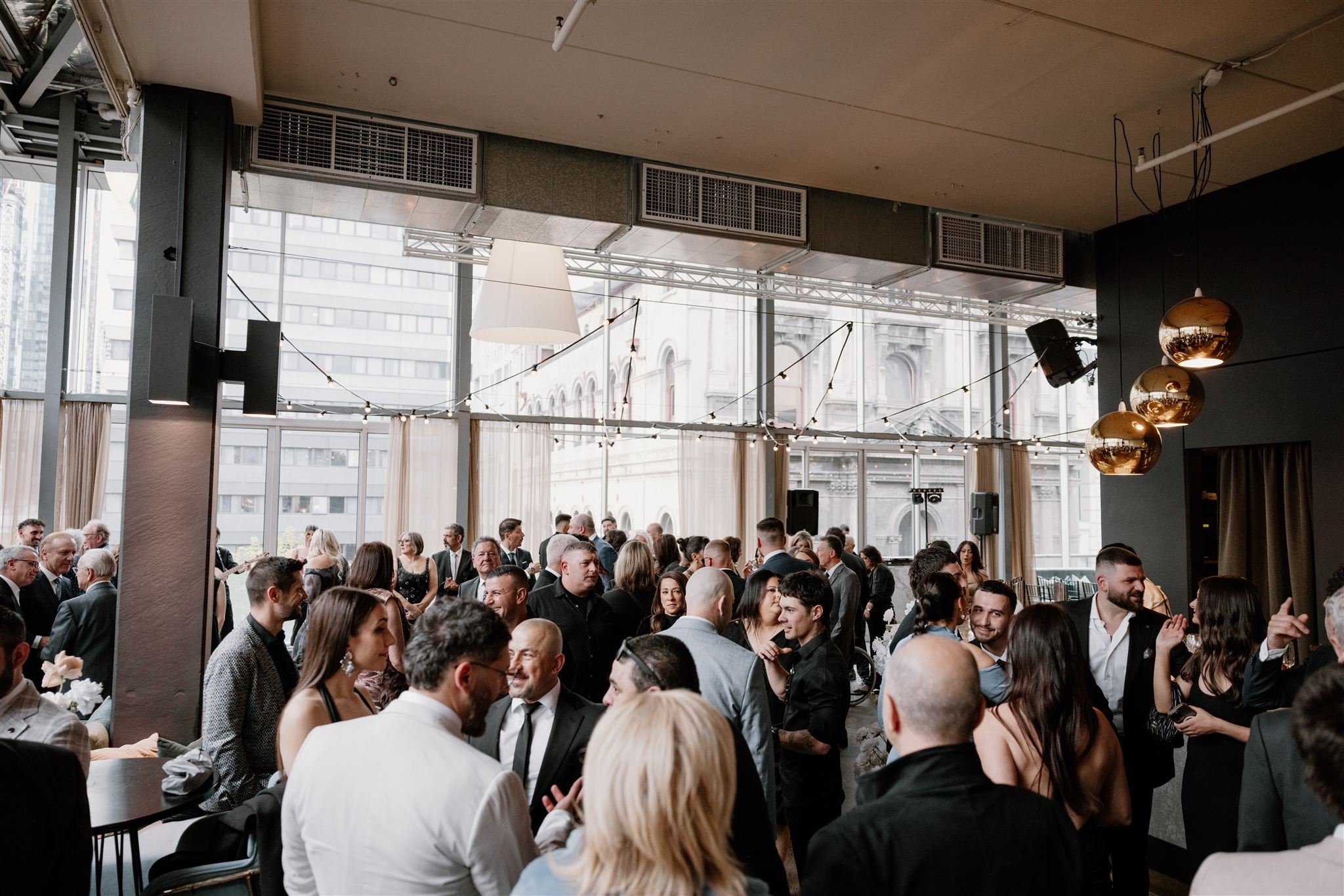 Guests mingling at a cocktail event at Alto Event Space Melbourne