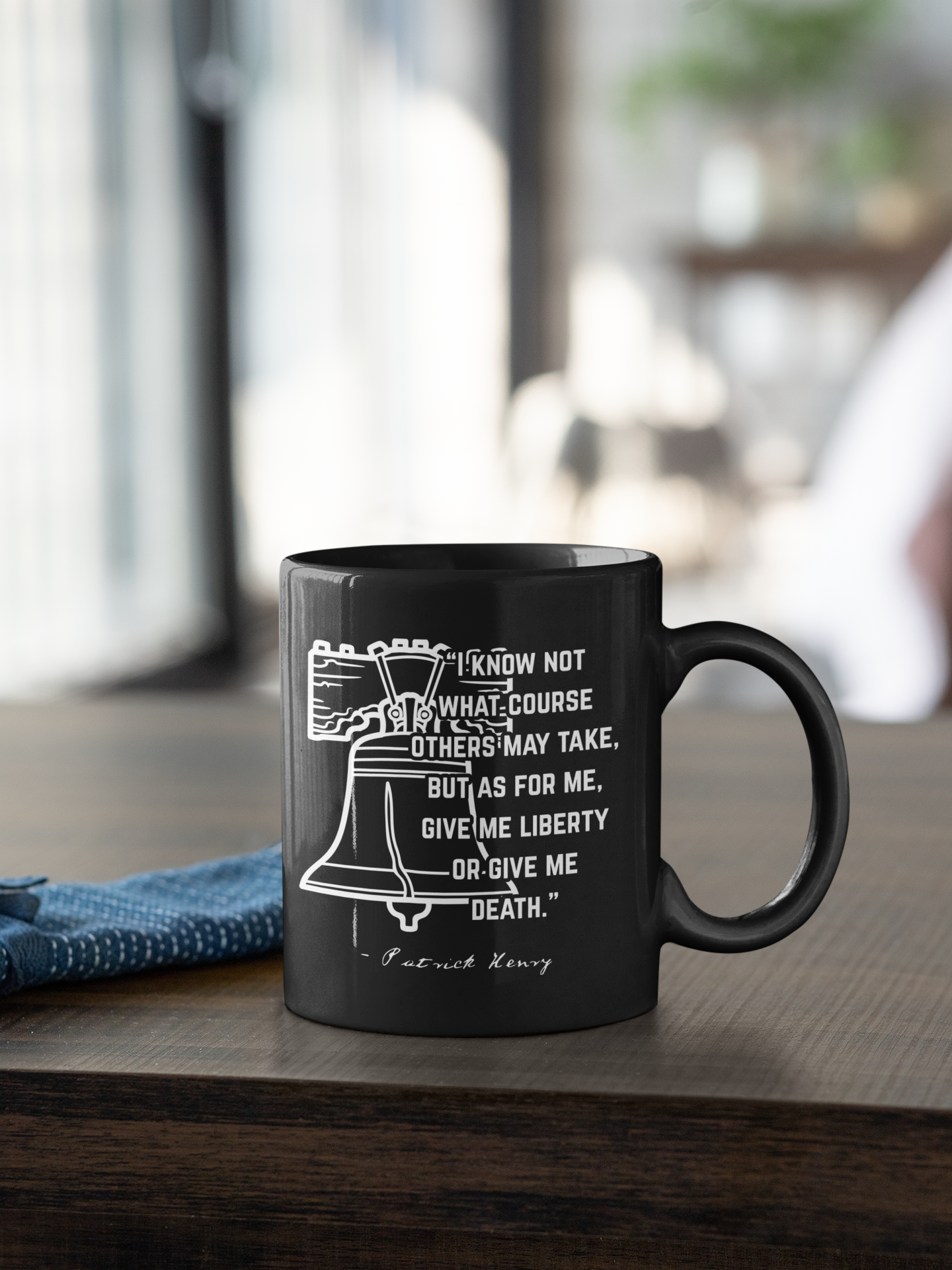Black mug featuring a white illustration of the Liberty Bell with a quote from Patrick Henry about liberty and death.