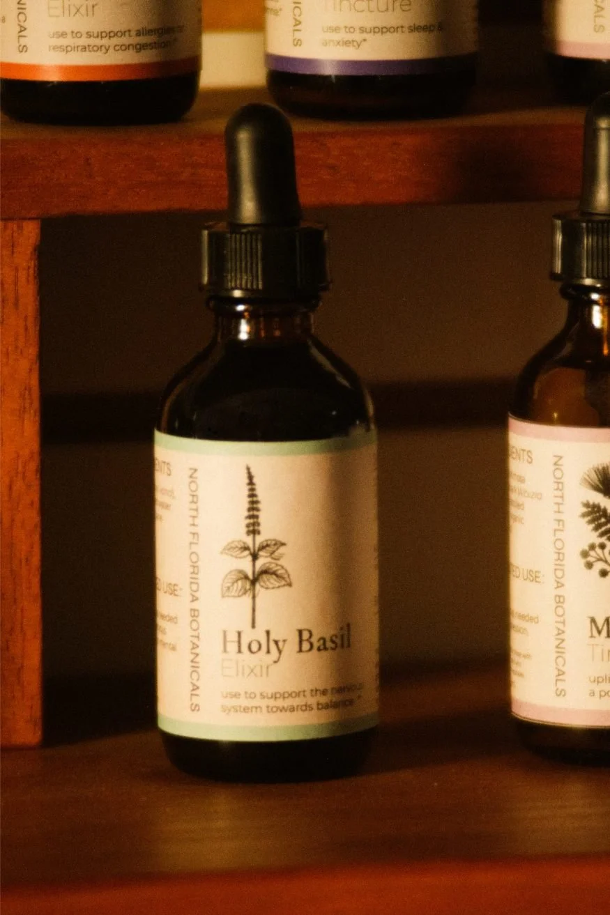 A dark brown dropper bottle labeled Holy Basil.