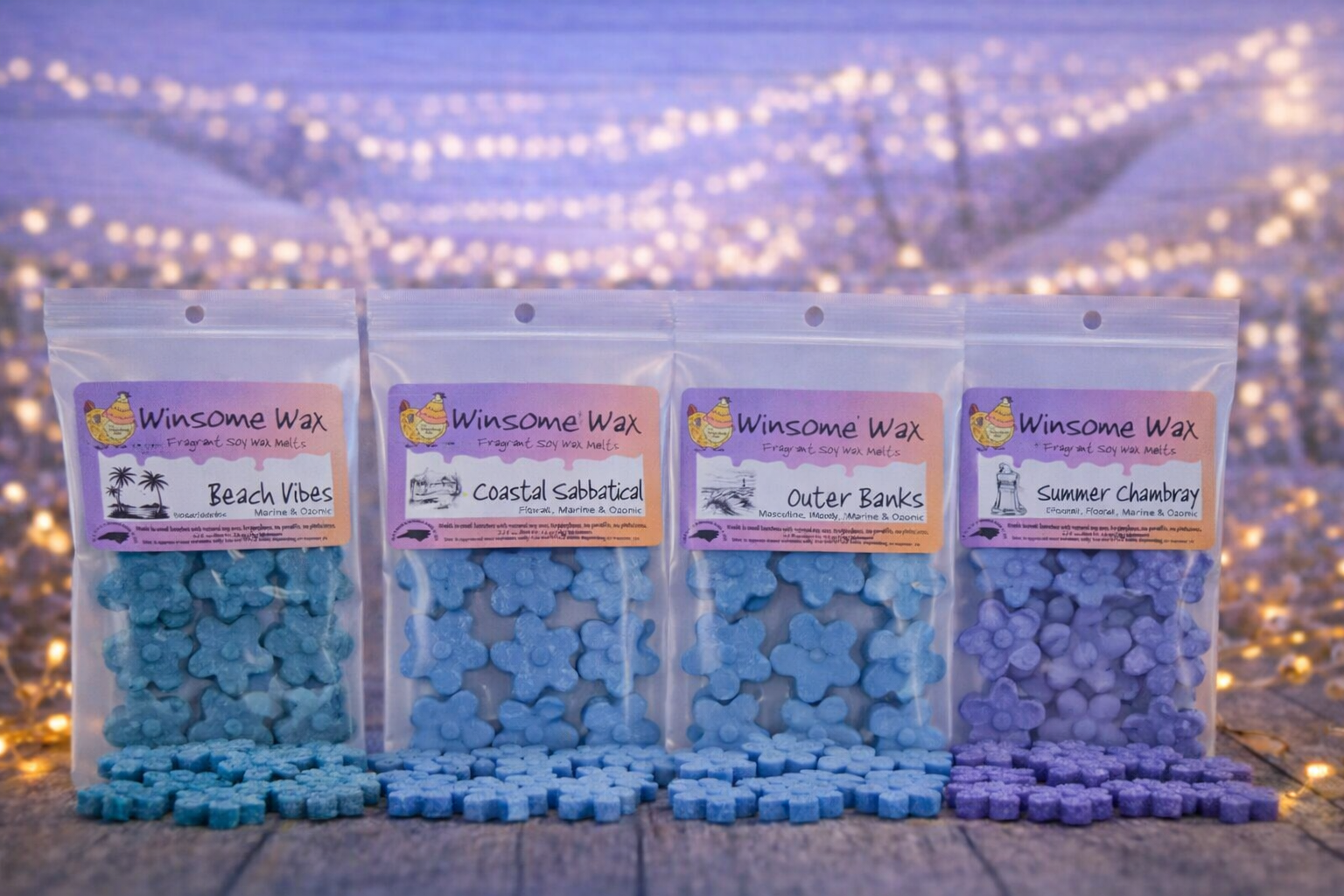Four packets of Winsome Wax soy wax melts labeled Beach Vibes, Coastal Sabbatical, Outer Banks, and Summer Chambray, with the wax melts spilled in front of each packet, set against a background of string lights and a wooden surface.