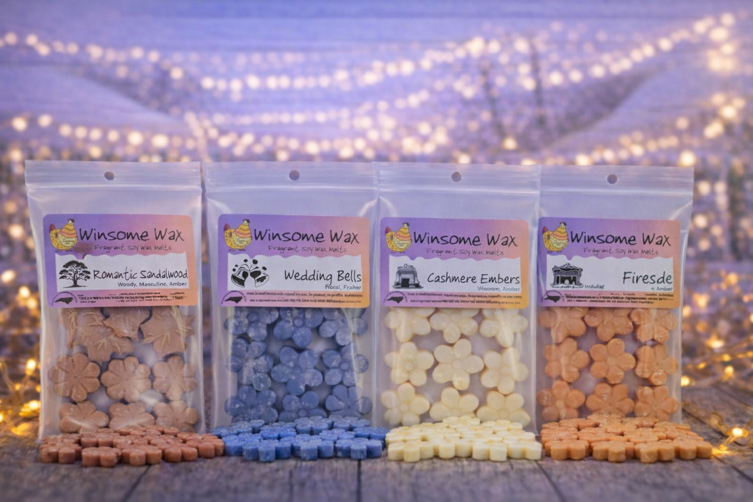 Four packs of Winsome Wax scented soy wax melts with different fragrances, displayed outdoors on a wooden surface with fairy lights in the background.