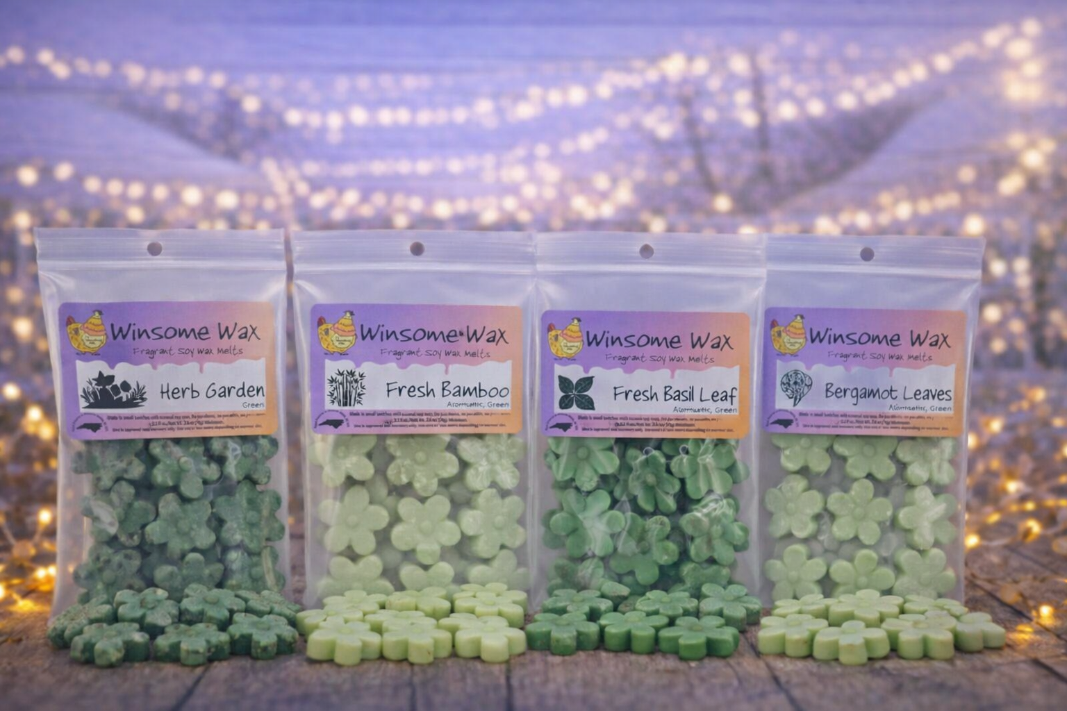 Four bags of Winsome Wax soy wax melts in different scents, including Herb Garden, Fresh Bamboo, Fresh Basil Leaf, and Bergamot Leaves, displayed on a wooden surface with string lights in the background.