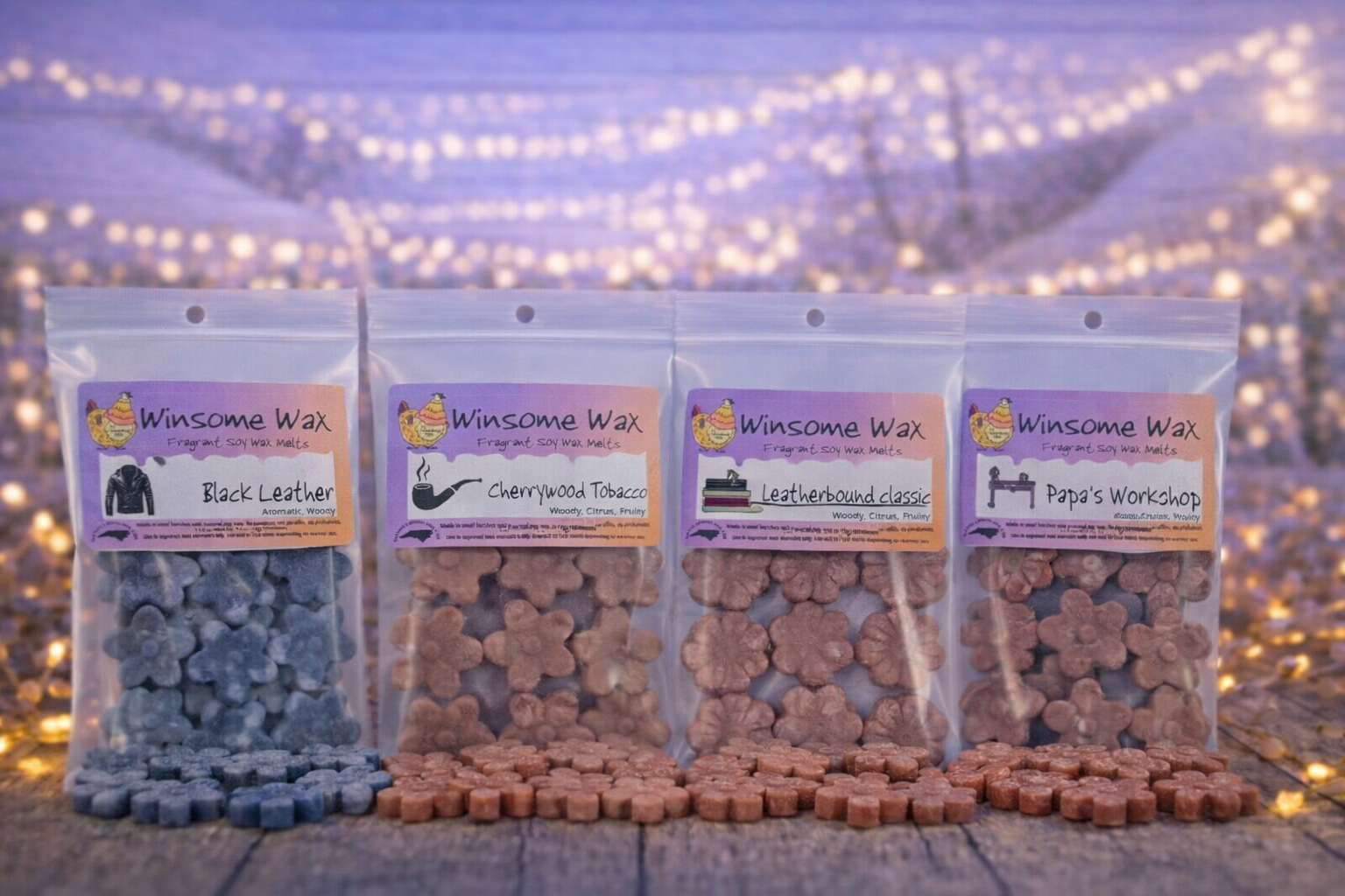 Four packages of Winsome Wax fragrant soy wax melts in various scents, with small flower-shaped wax pieces arranged in front of each package, set against a bokeh background of twinkling lights.