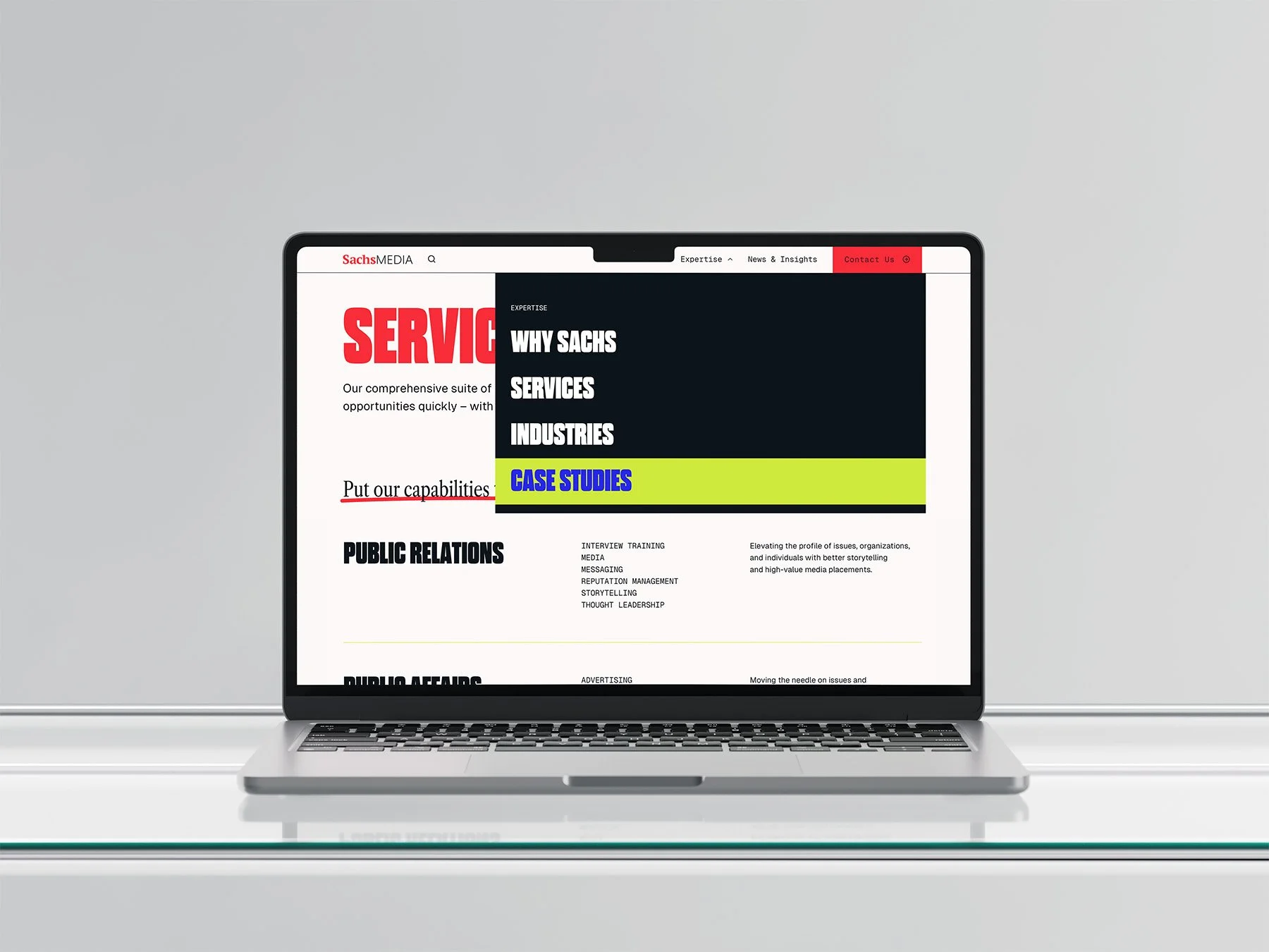 Laptop displaying a website with a menu overlay and a highlighted button labeled 'CASE STUDIES' in blue with a yellow background.