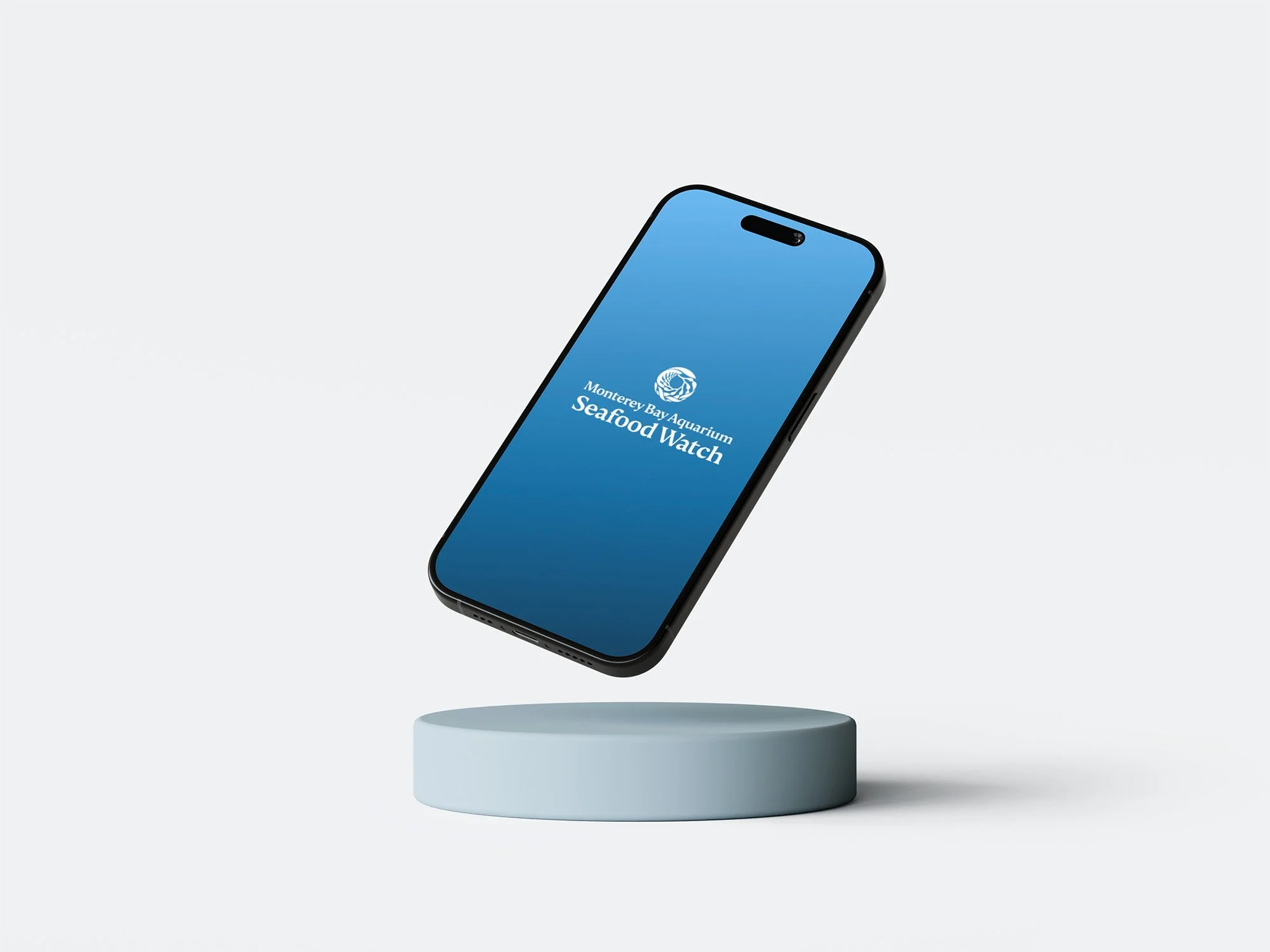 Smartphone displaying 'Monterey Bay Aquarium Seafood Watch' logo, suspended above a round platform.