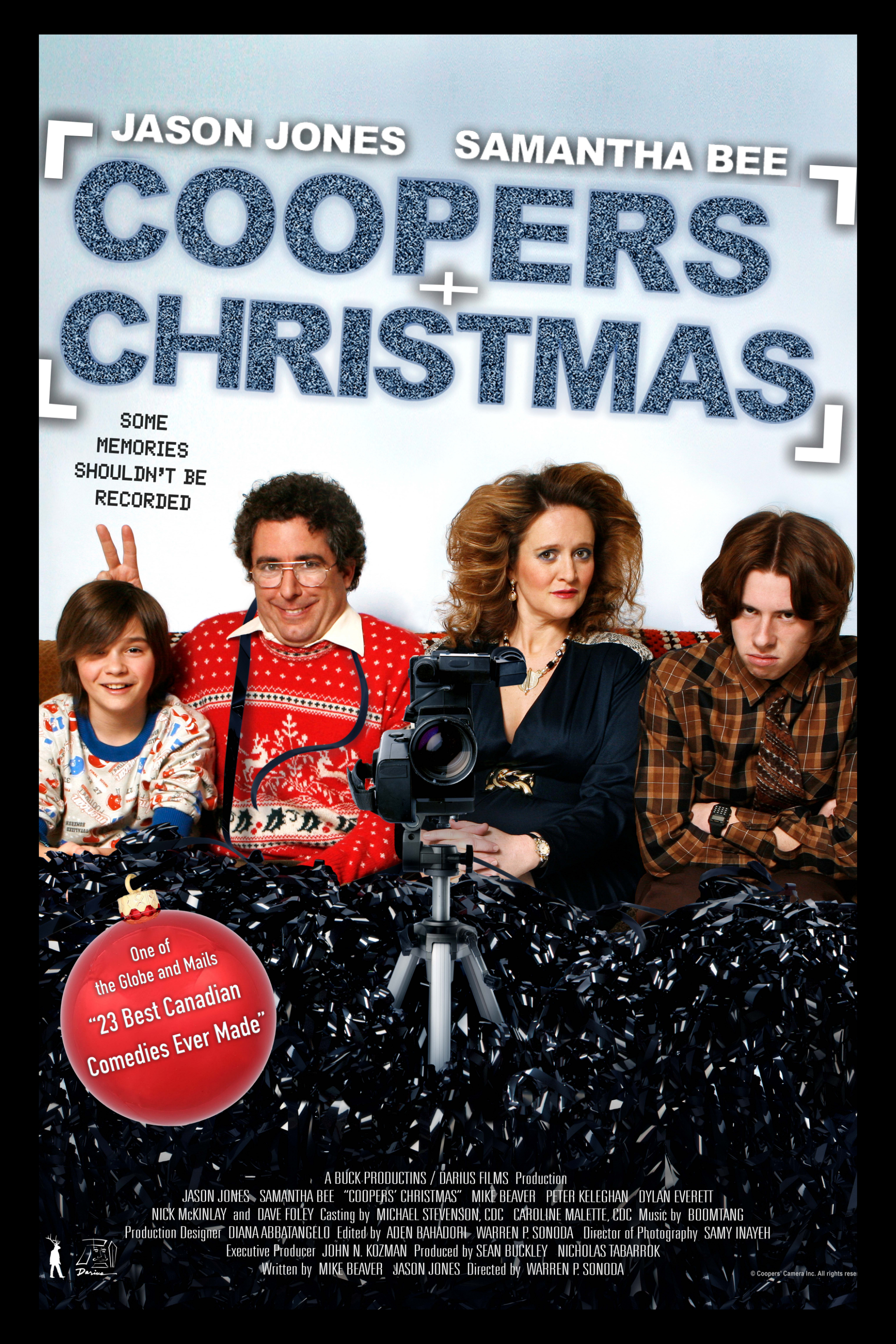 Poster for the movie "Coopers Christmas" featuring four characters sitting on a couch with Christmas decorations and a camera in front of them. The title is displayed prominently at the top, with the names Jason Jones and Samantha Bee above it. A red ornament with white text highlights the film as one of the best Canadian comedies.