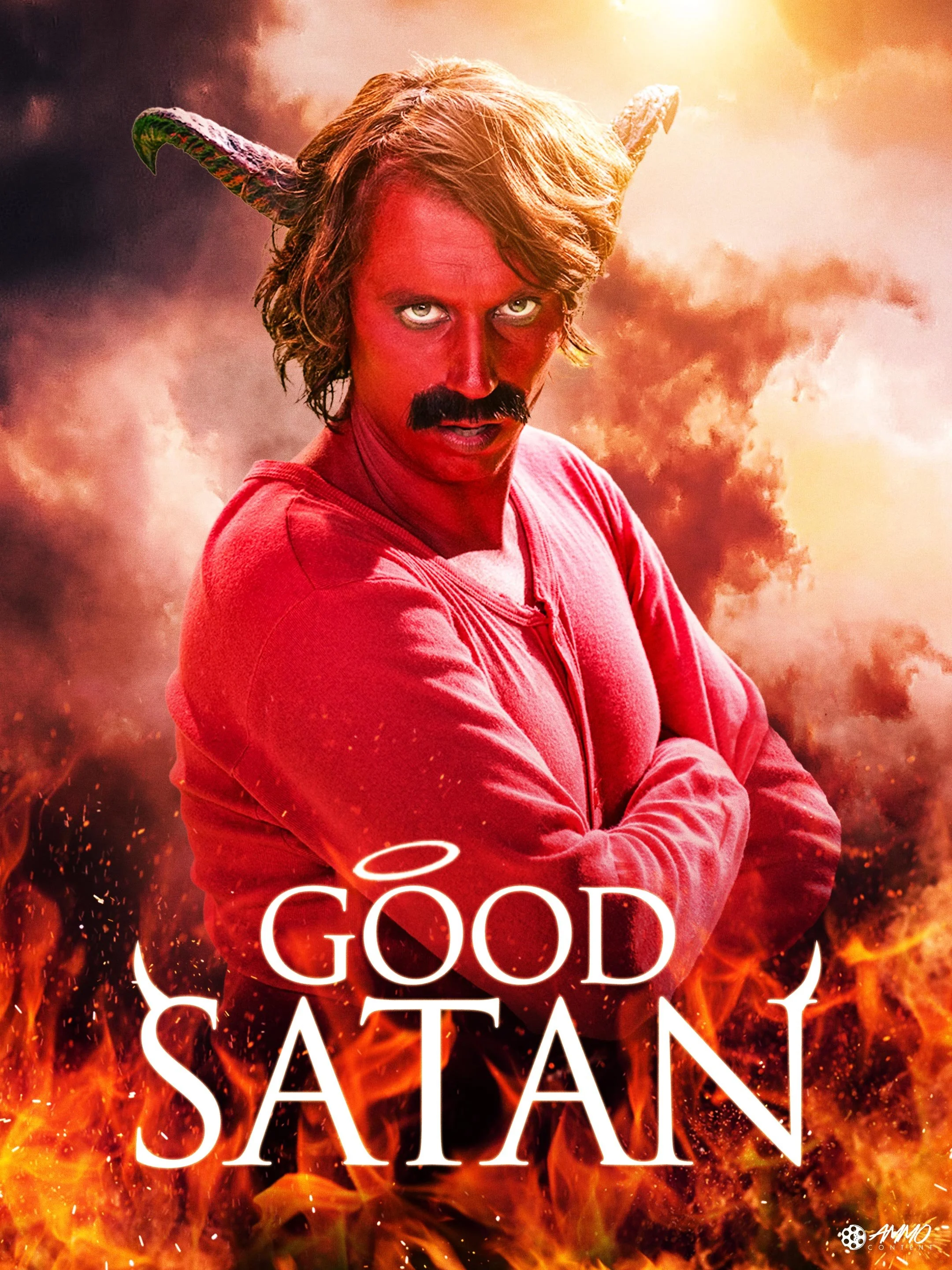 A man with a mustache and wavy hair dressed as Satan with horns, red face, wearing a red hoodie, standing in front of flames and smoke with the title 'Good Satan' and a small halo above the 'O'.