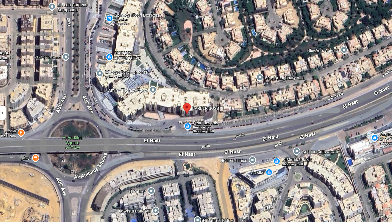 Satellite map showing a city area with roads, buildings, a roundabout, and landmarks such as a shopping mall, clinics, and residential neighborhoods.