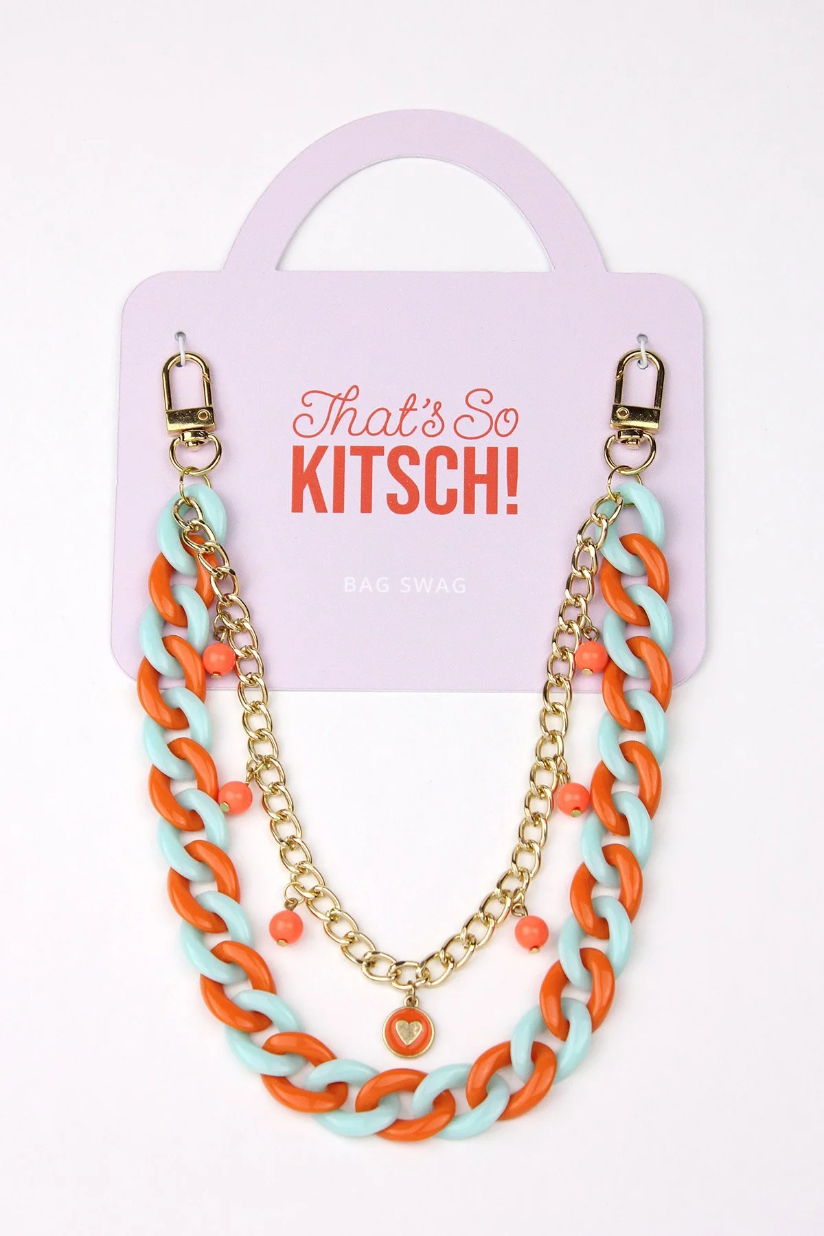 Colorful chain necklaces with orange and light blue links, small orange beads, and a charm with a heart on a purple card that says "That's So KITSCH! BAG SWAG".