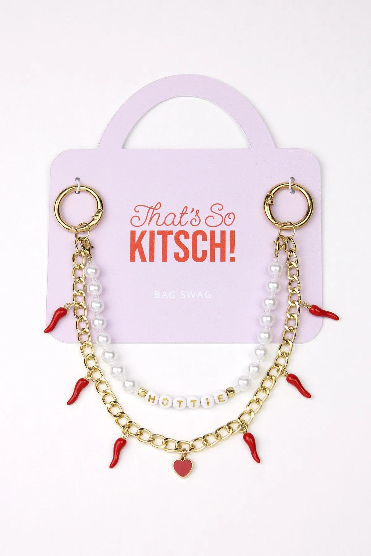 Pair of fashion earrings and a necklace on a pink card with the words "That's So KITSCH!" in bold red and orange, with small white letters reading "BAG SWAG" at the bottom.