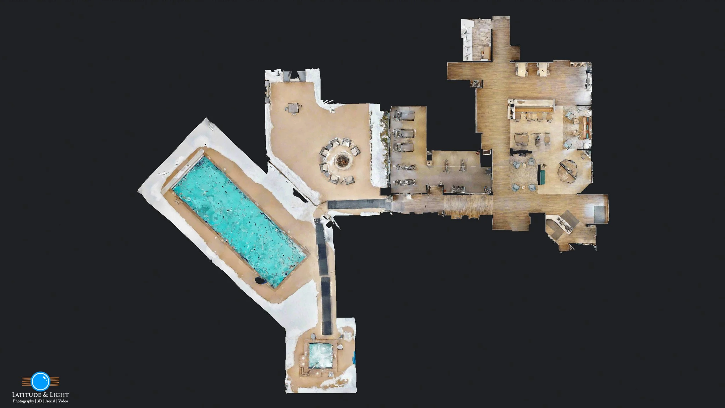 A top-down aerial view of a Kalispell ski hotel with a Swimming pool in the patio area, a hot tub, a patio with outdoor furniture, and a large interior with multiple rooms including a living area, dining space, and kitchen.
