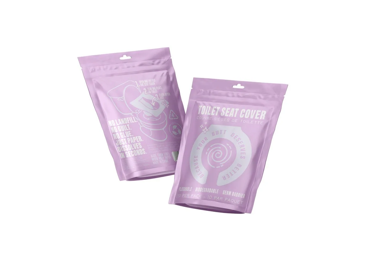 Two purple packages of toilet seat covers with white text and graphics, one showing a diagram of installation and the other with a spiral design and the words 'Your butt deserves better'.