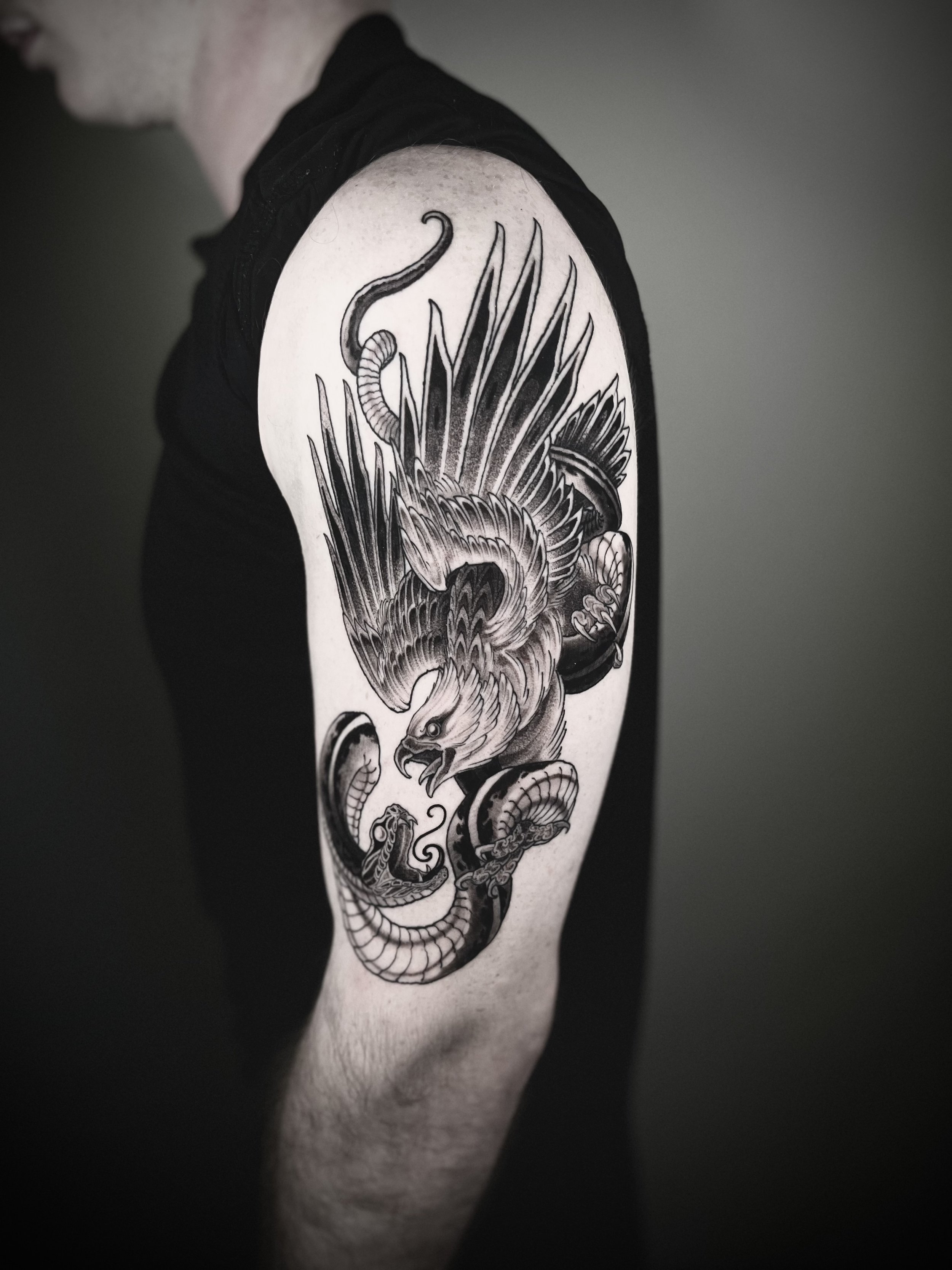 ashtrae-neotrad-blackwork-battle-royale-eagle-snake-tattoo.jpeg