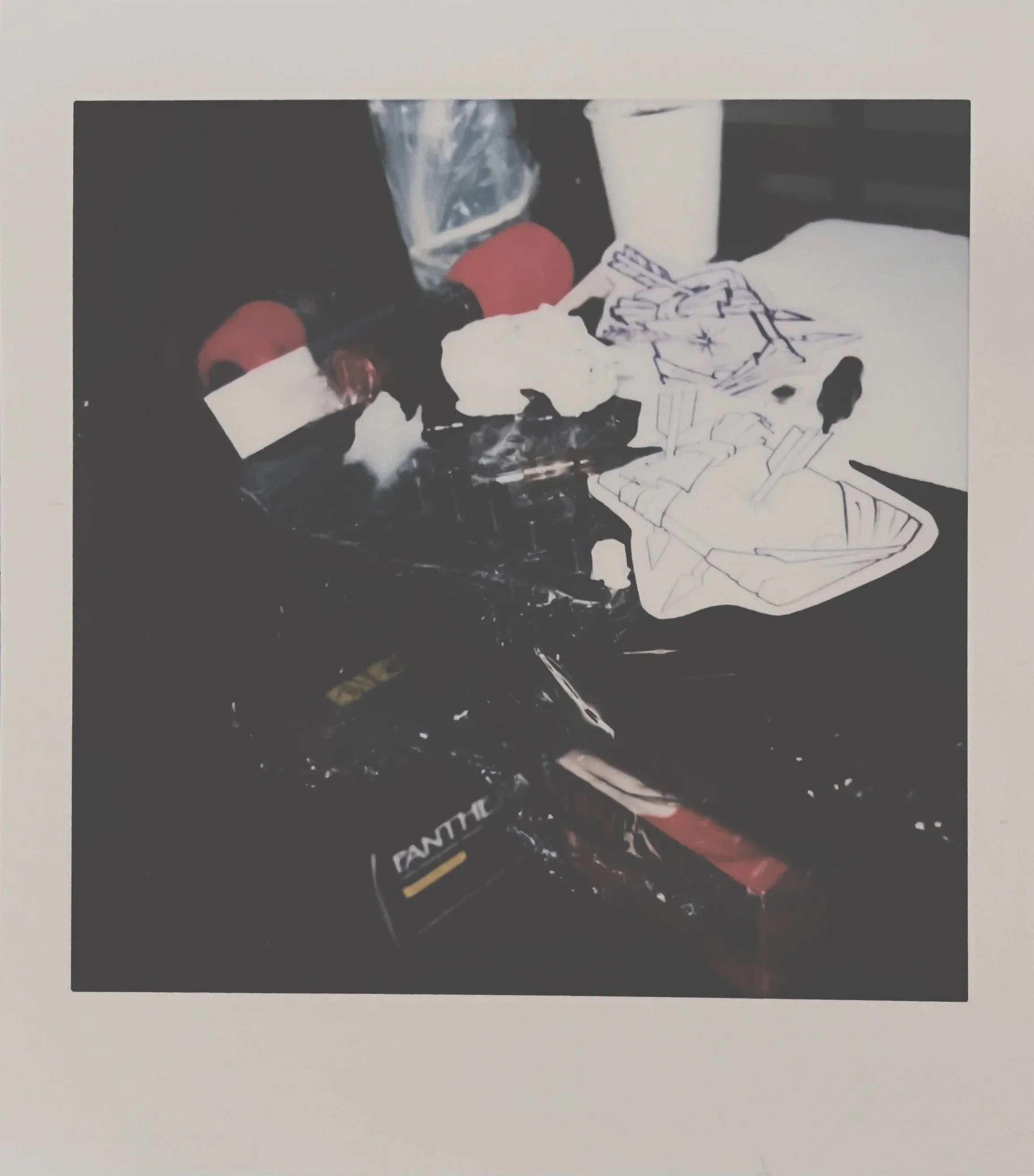 Tattoo work station with tattoo machine, stencil, inks, needles and ink caps.