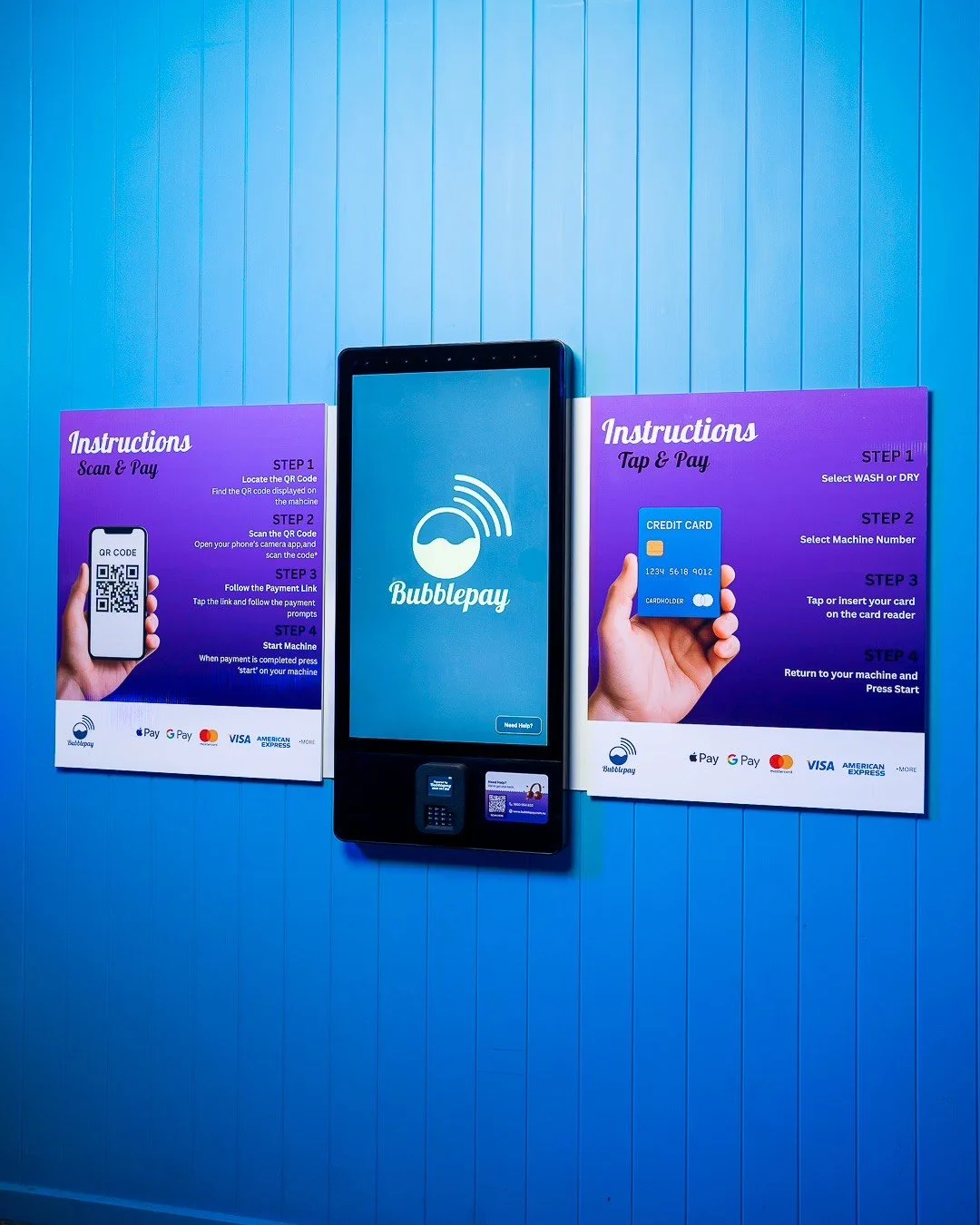 Signage with instructions for Bubblepay contactless payment, including steps for scan & pay with a QR code and tap & pay with a credit card, displayed on a blue wall.