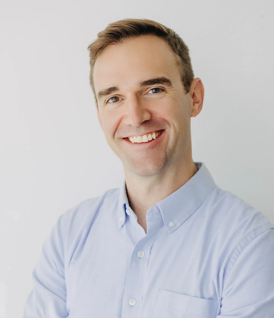 Photo of a smiling real estate agent with a blue shirt and short brown hair. He helps buyers and sellers in Northeast Los Angeles neighborhoods like Eagle Rock, Highland Park and Mt. Washington