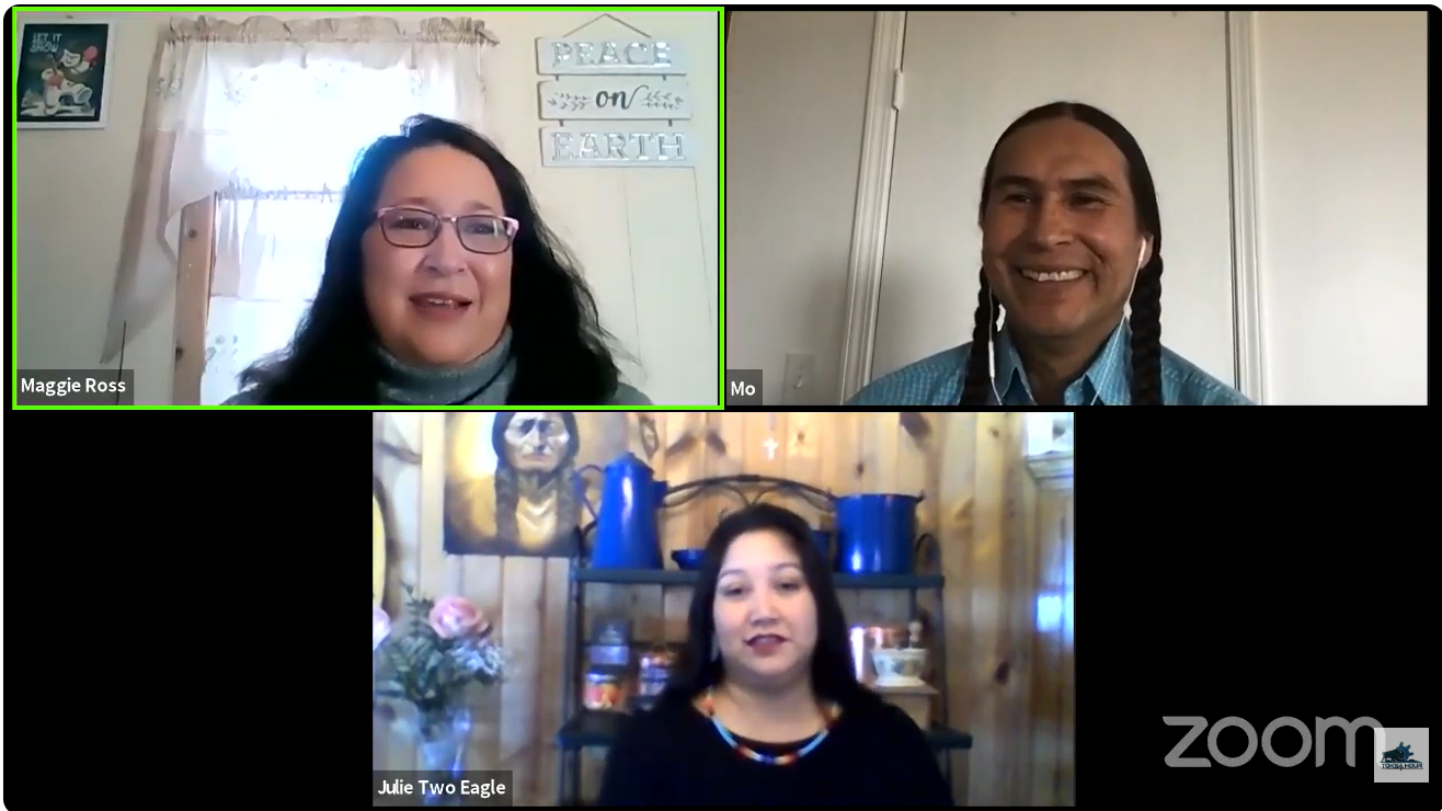 Three people participating in a Zoom call. The woman in the top left corner has glasses and dark hair, with a background that includes a window, curtains, and wall decorations. The man in the top right corner has long braided hair and a background with a plain wall. The woman in the bottom center has dark hair and a background with wooden paneling, a shelf with jars, a printed portrait, and flowers.