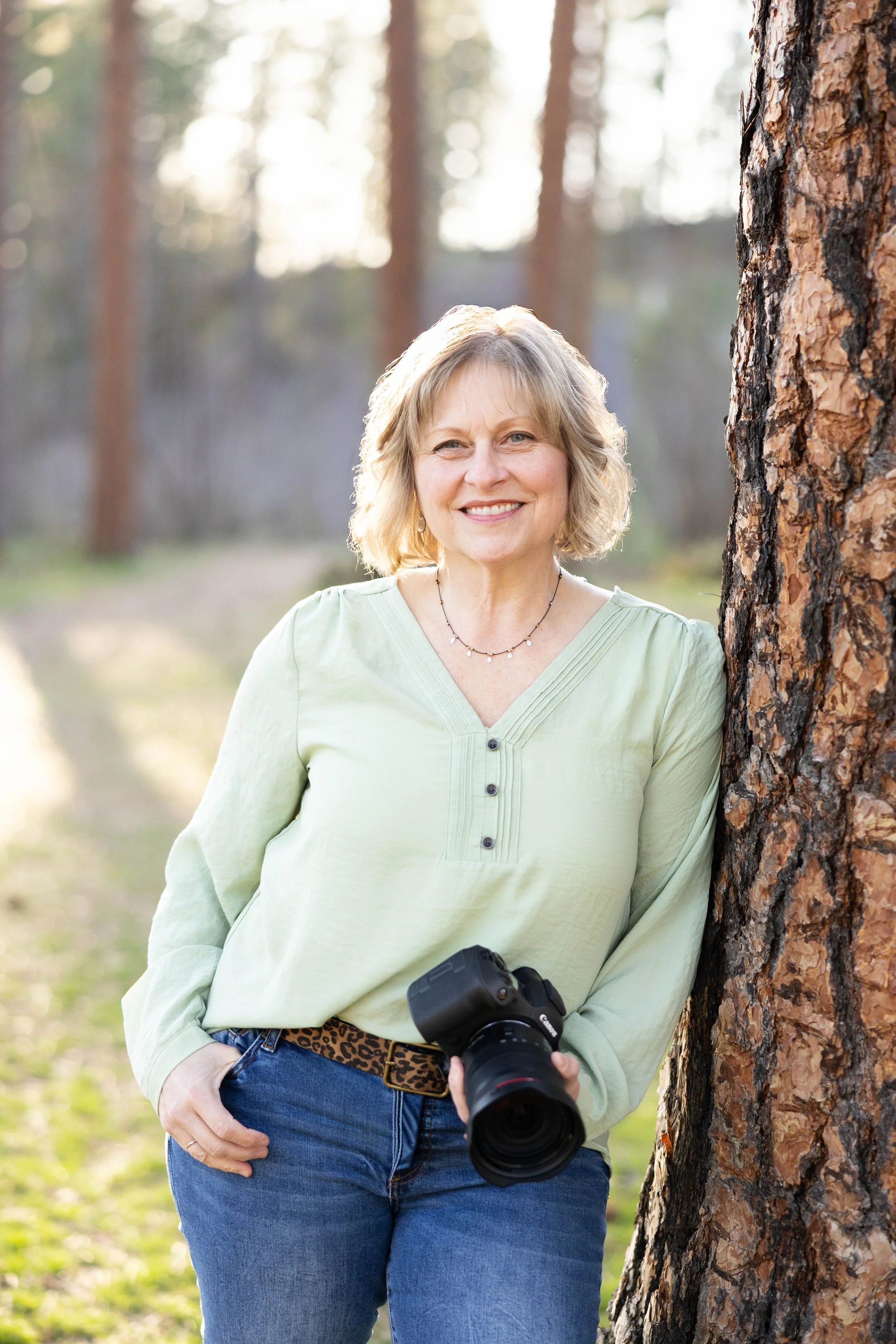 Picture of Desiree Hildenbrand holding a camera taken by Addyson Little Photography.
