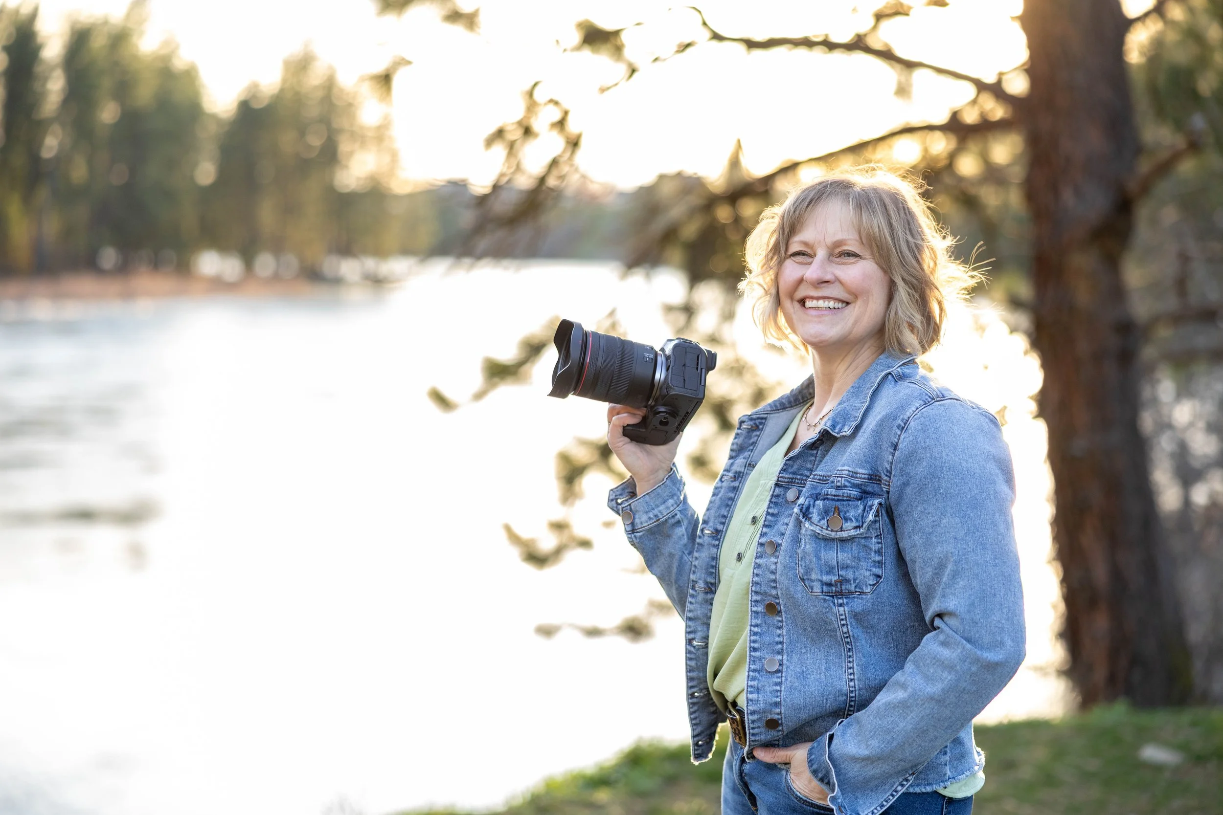Picture of Desiree Hildenbrand holding a camera taken by Addyson Little Photography.