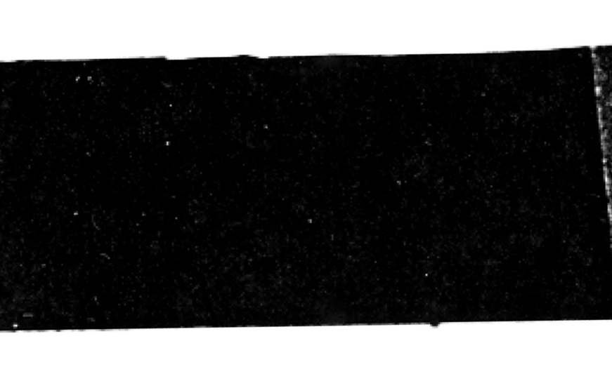 Close-up of a black, textured surface, possibly fabric or a matte material.