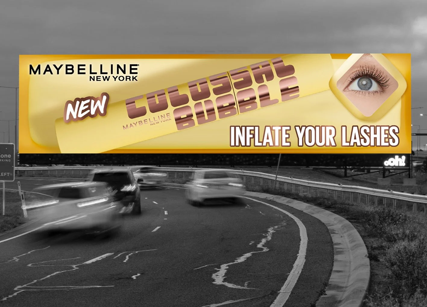 A billboard advertisement on a highway for Maybelline's new Cosmetic Bubble product, with a large image of a woman’s eye and the tagline "Inflate Your Lashes."