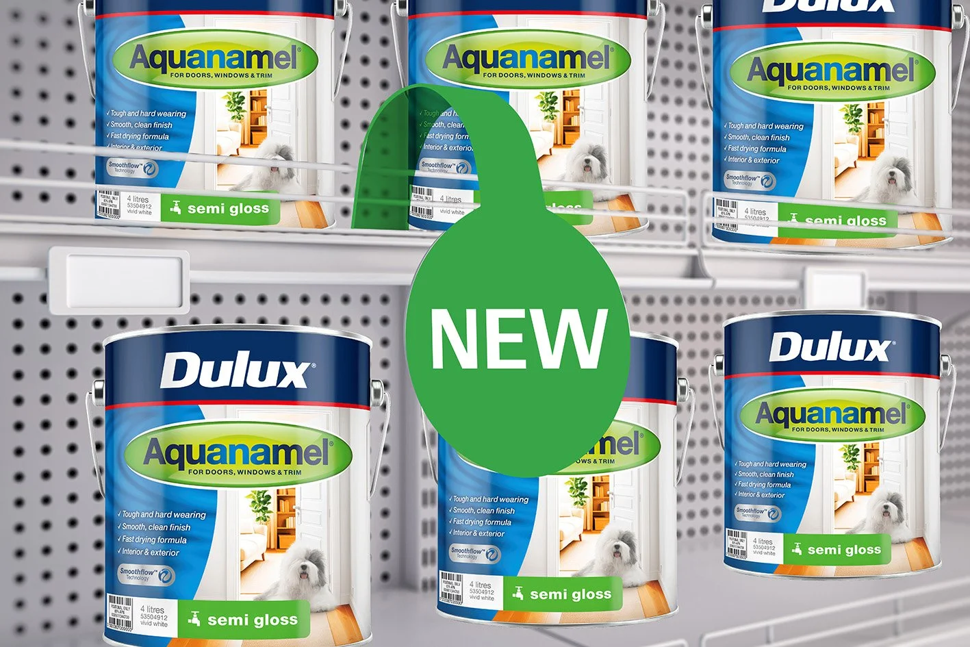 Shelf with cans of Dulux Aquanamel semi-gloss paint labeled as new, in blue and green packaging, and cans of the previous Dulux product, showing a store display.