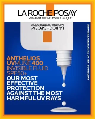 A tube of La Roche-Posay Anthelios UV Mune 400 Invisible Fluid sunscreen with SPF 50+ and droplet of product falling from the tube.