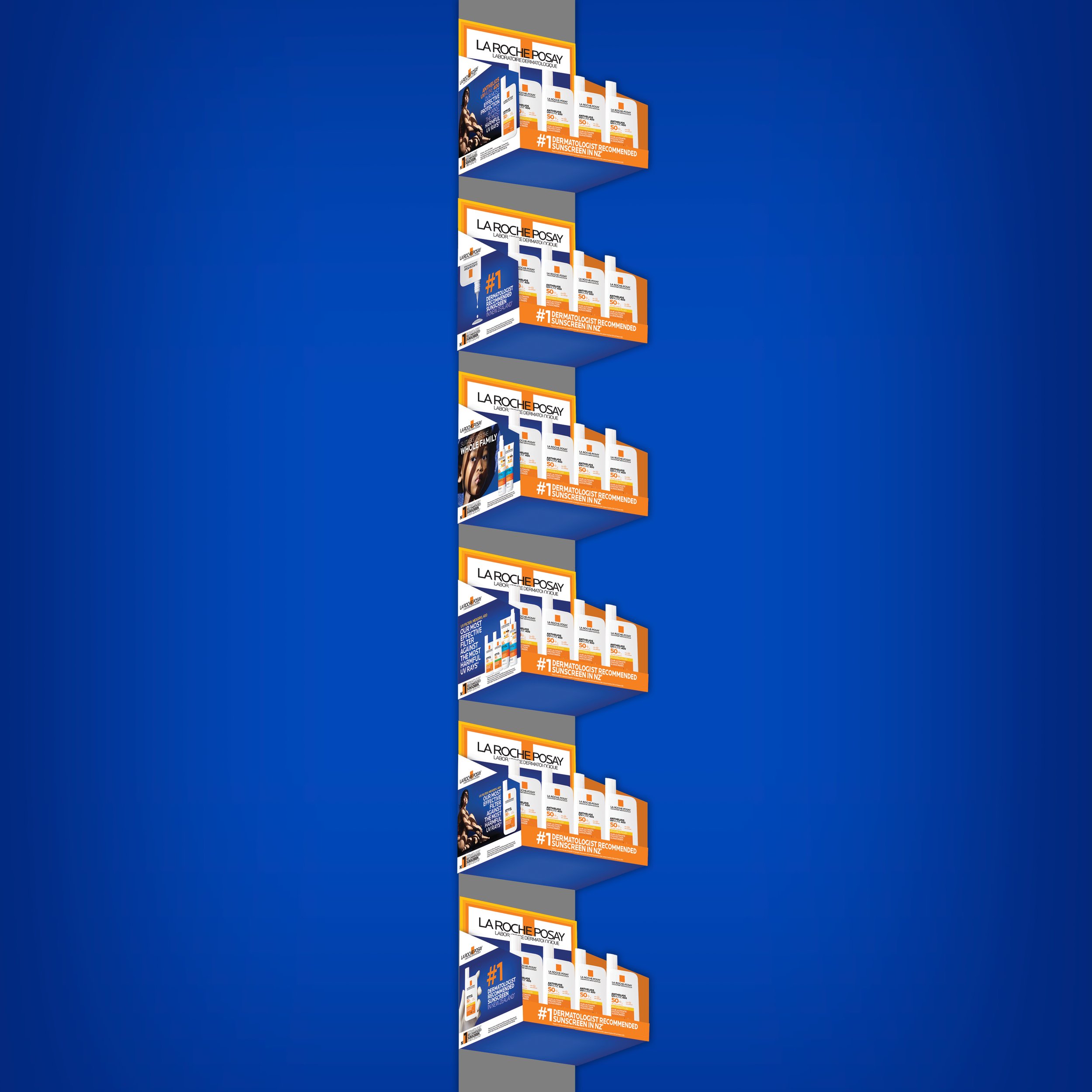 Display shelf with La Roche-Posay sunscreen products, with packaging in white, orange, and blue, on a blue background.