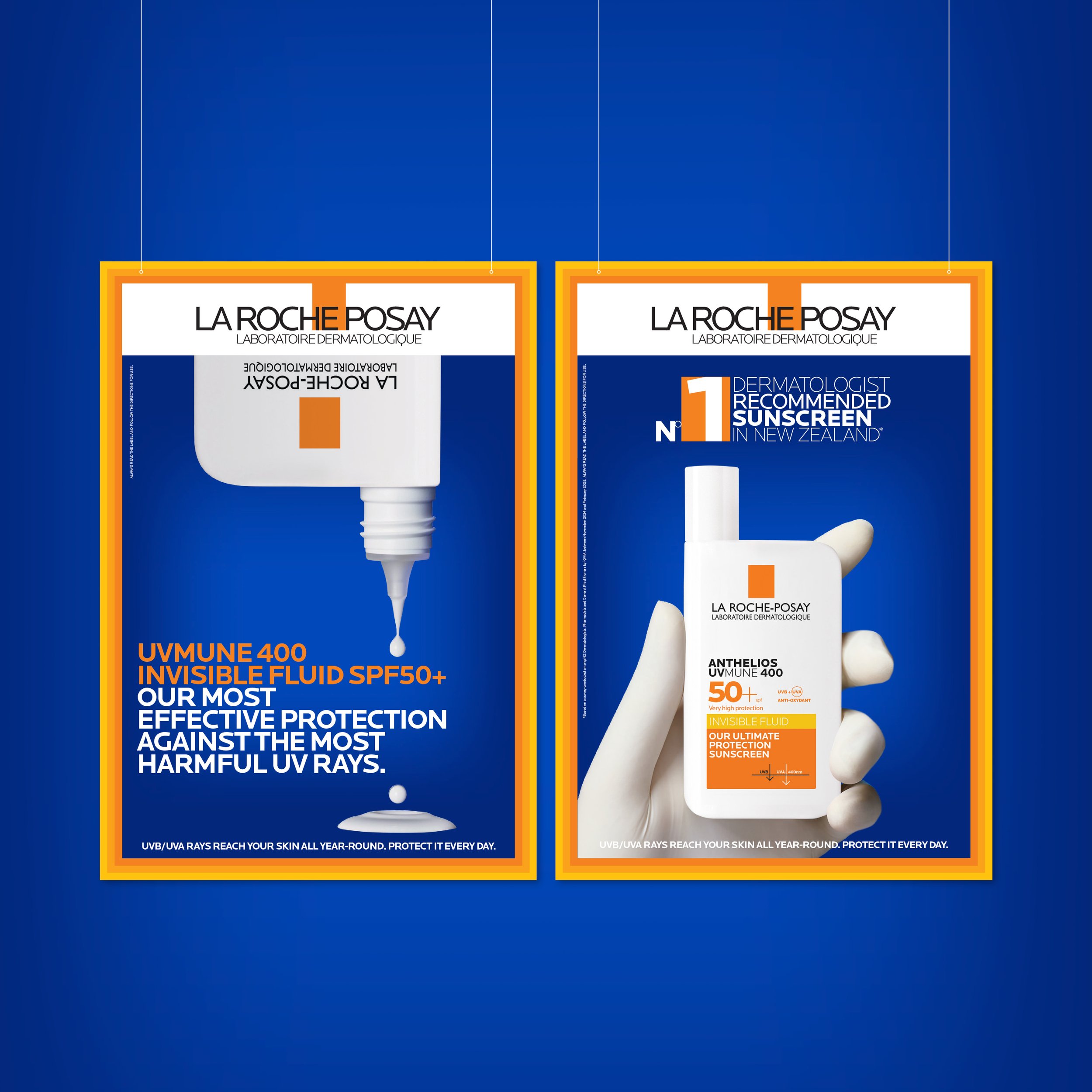 Two skincare product packages from La Roche-Posay. The left package highlights UVB/UVA rays protection with SPF 50+ for invisible fluid, and the right package emphasizes anti-oxidant protection for skin with SPF 50+. Both packages feature white bottles with orange and blue accents against a blue background.