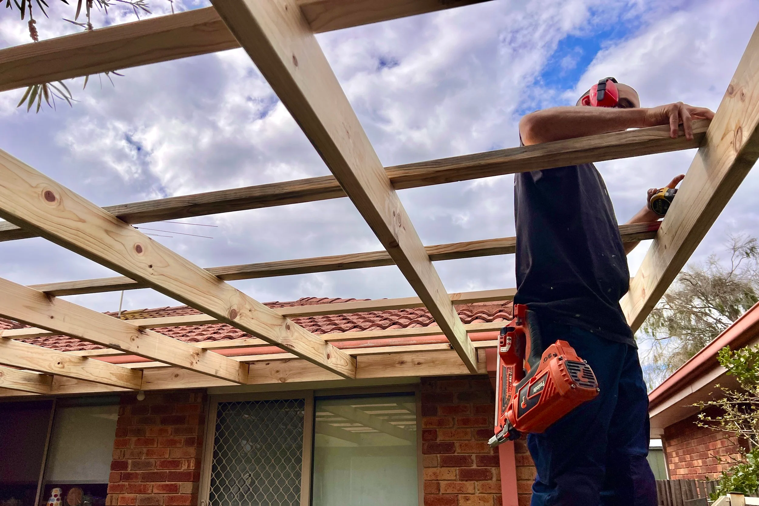 Oranssi technician working on a roof project