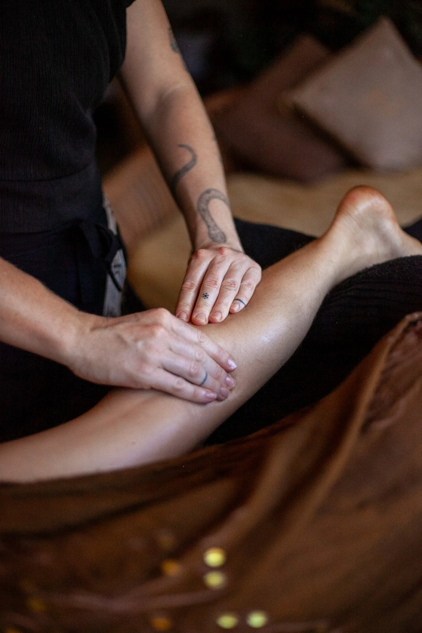 A person receiving a massage on their leg from a massage therapist.