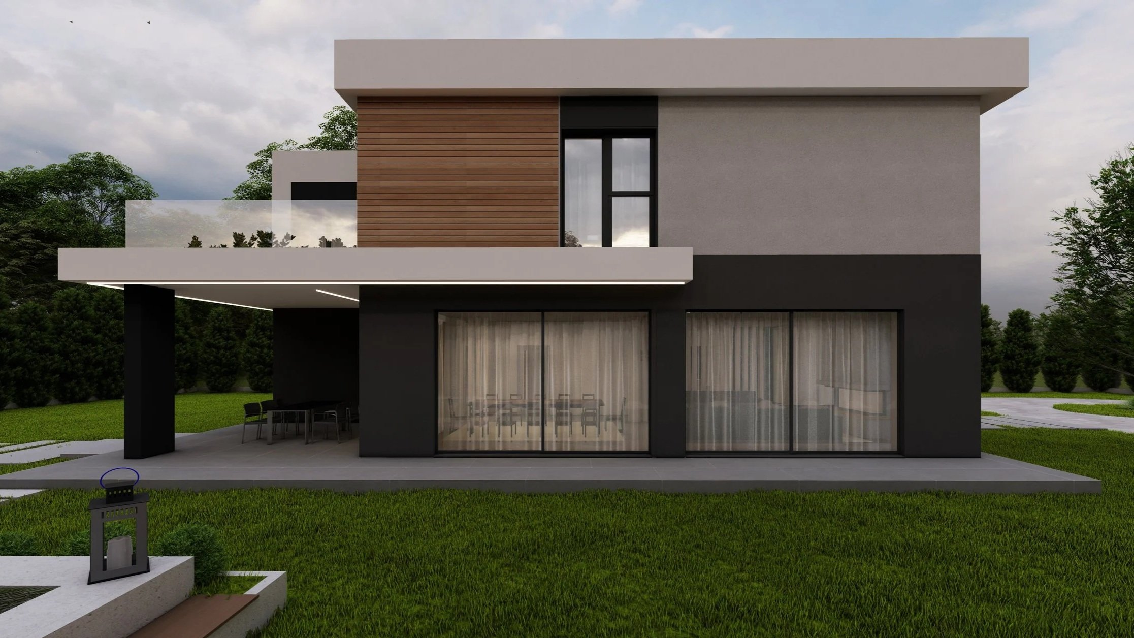 Modern two-story house with a flat roof, large sliding glass doors, and a balcony. The house has a mix of black, grey, and wooden exterior finishes. There is a patio with outdoor furniture and a well-maintained grassy yard with trees in the backgroun