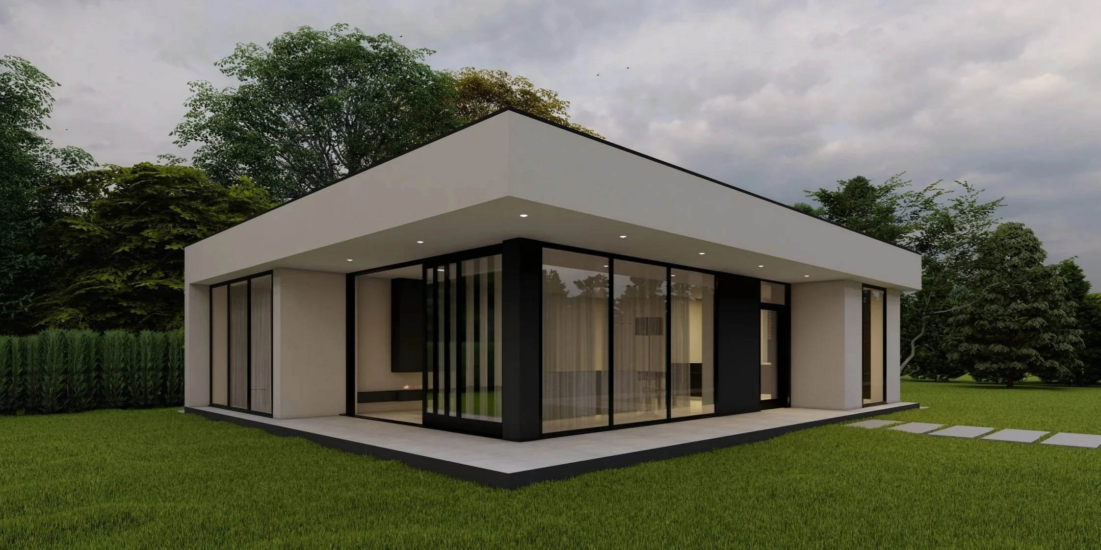 Modern single-story house with large glass windows, white exterior walls, surrounded by green grass and trees, under a cloudy sky.