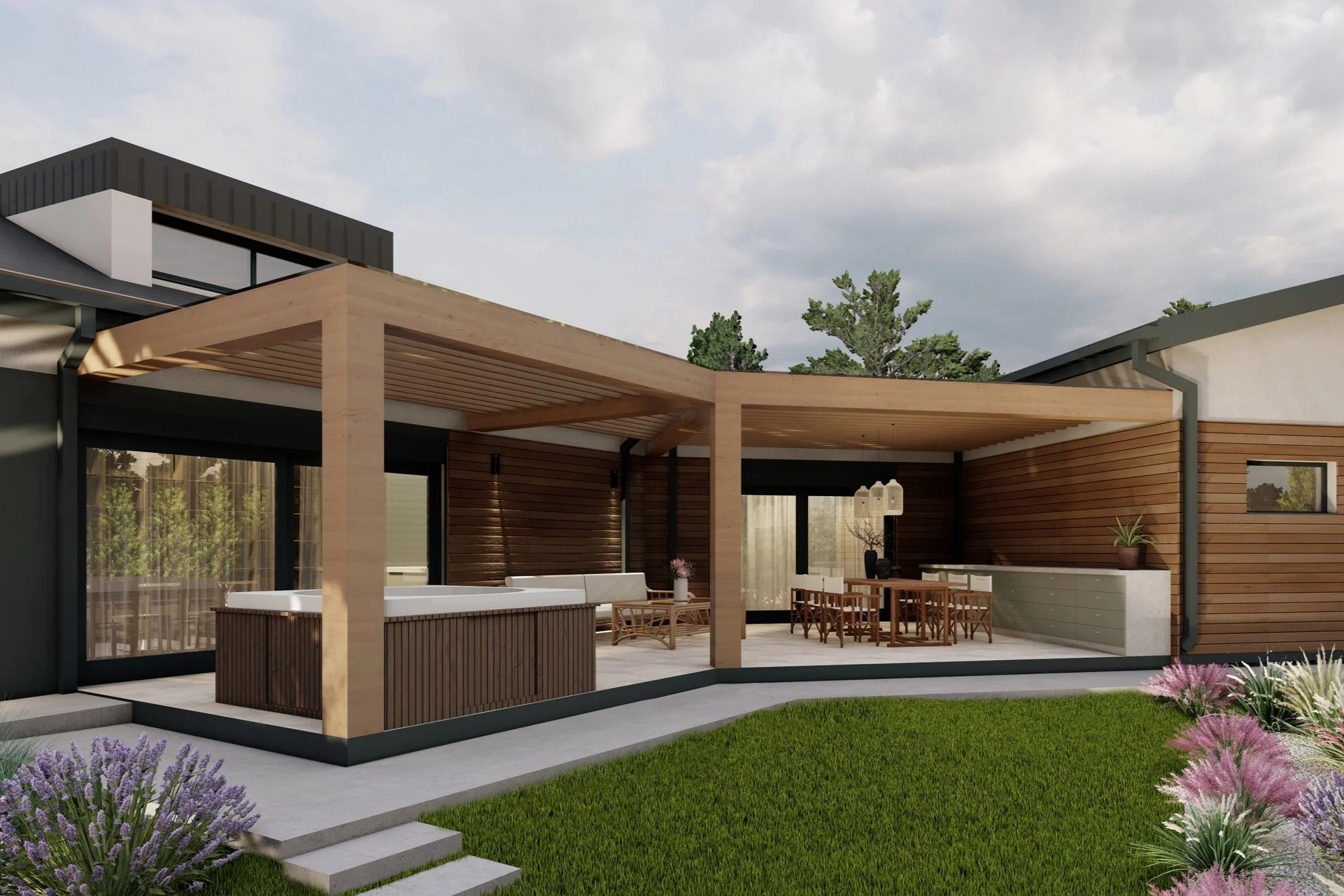 Modern outdoor patio area with a hot tub, dining table, and lounge seating, surrounded by a grassy yard with purple and pink flowers, under a partly cloudy sky.