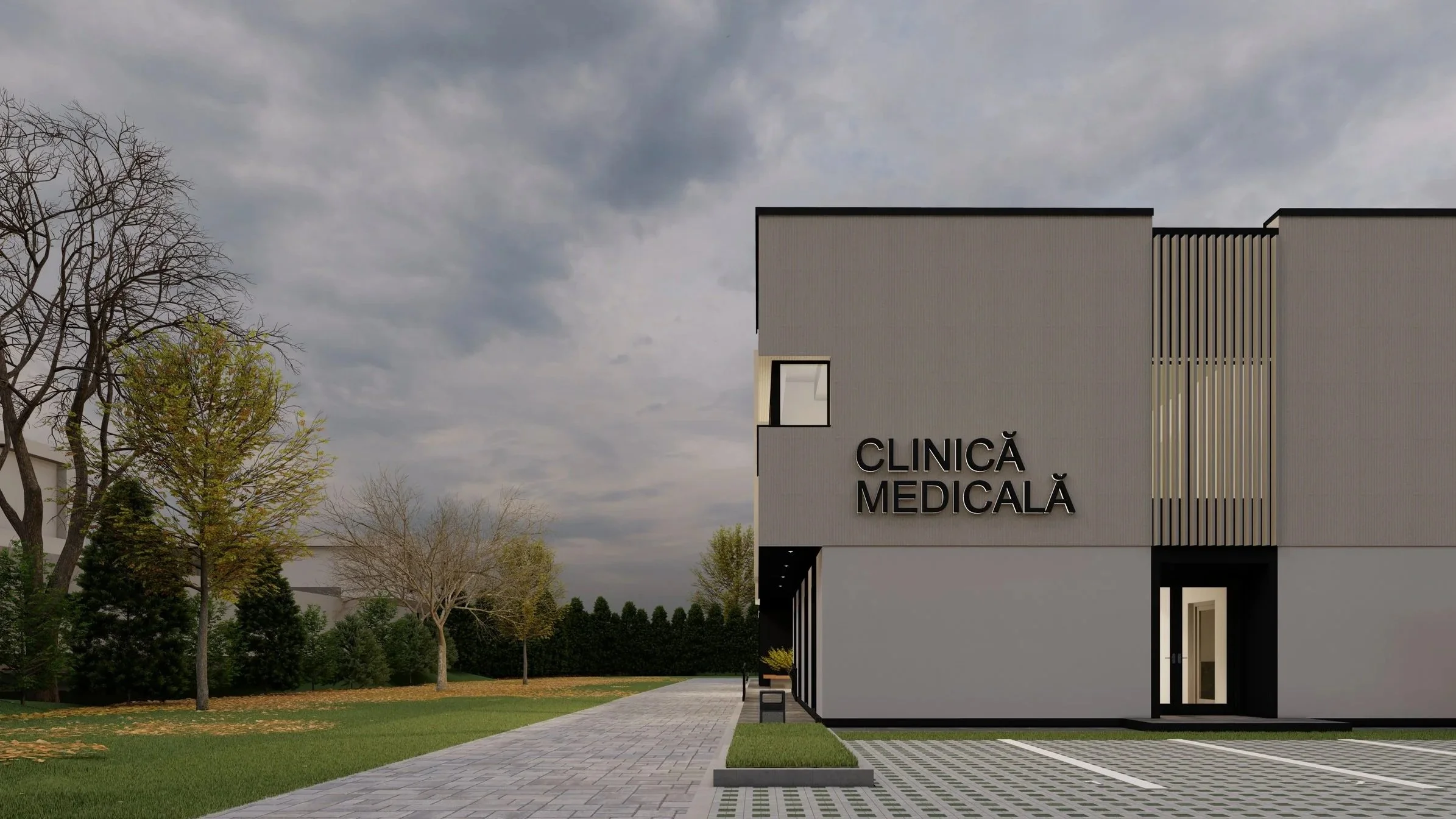 Modern medical clinic building with a sign reading 'Clinică Medicală' on the front, surrounded by a paved walkway, parking spaces, and trees with autumn foliage, under a cloudy sky.